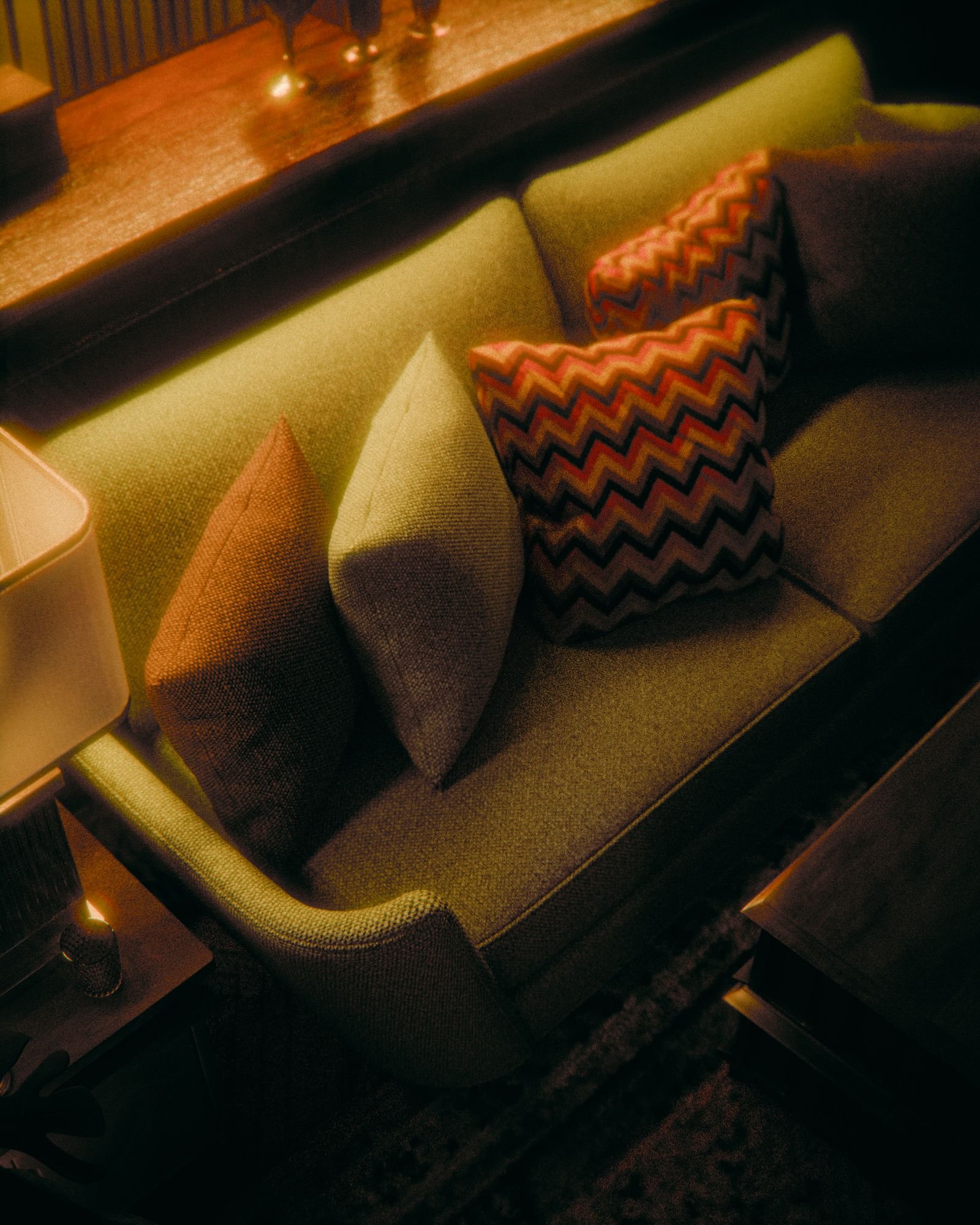 Retro living room with vibrant pillows and warm lighting.