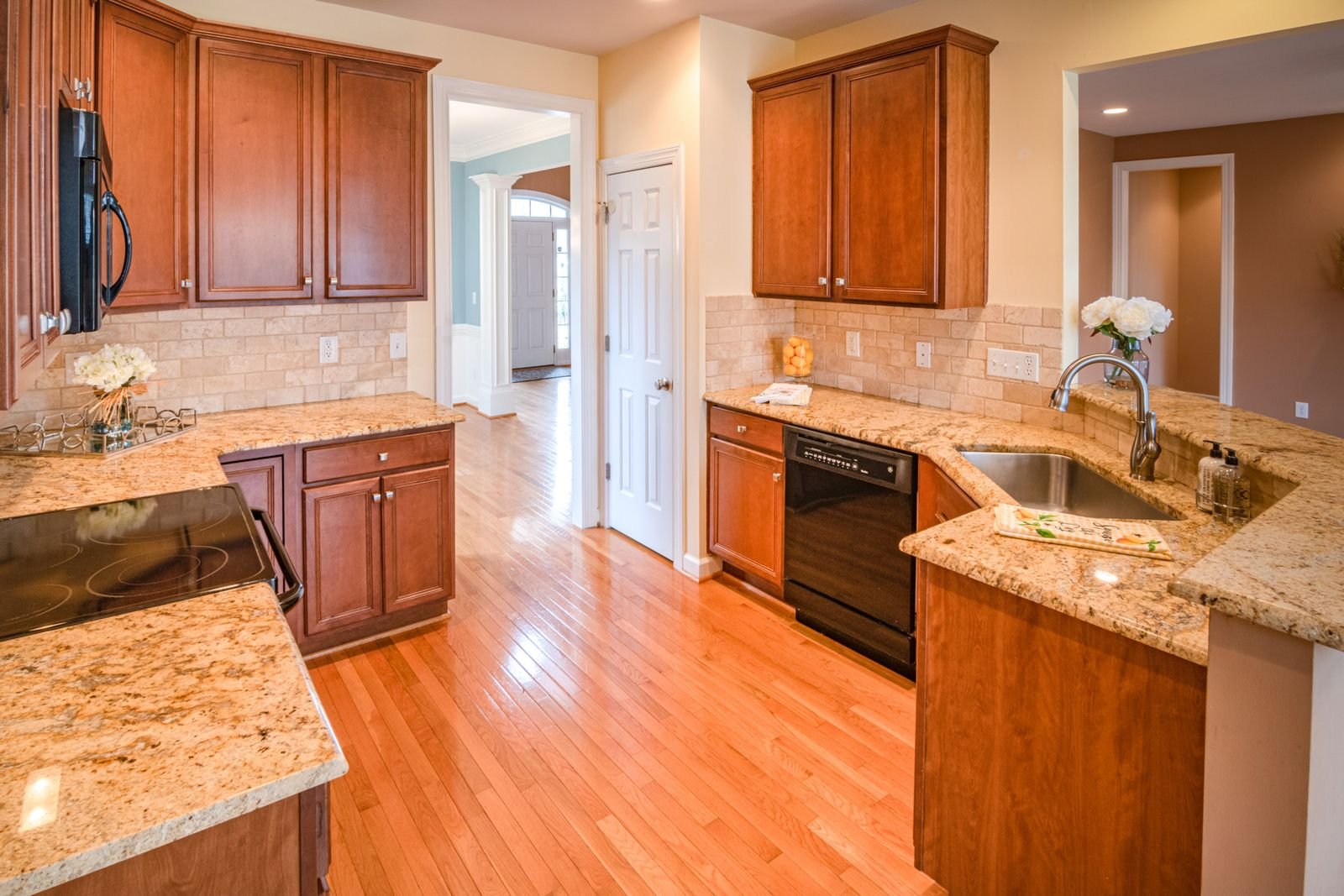 Bright kitchen with wooden cabinets paired with stone countertops