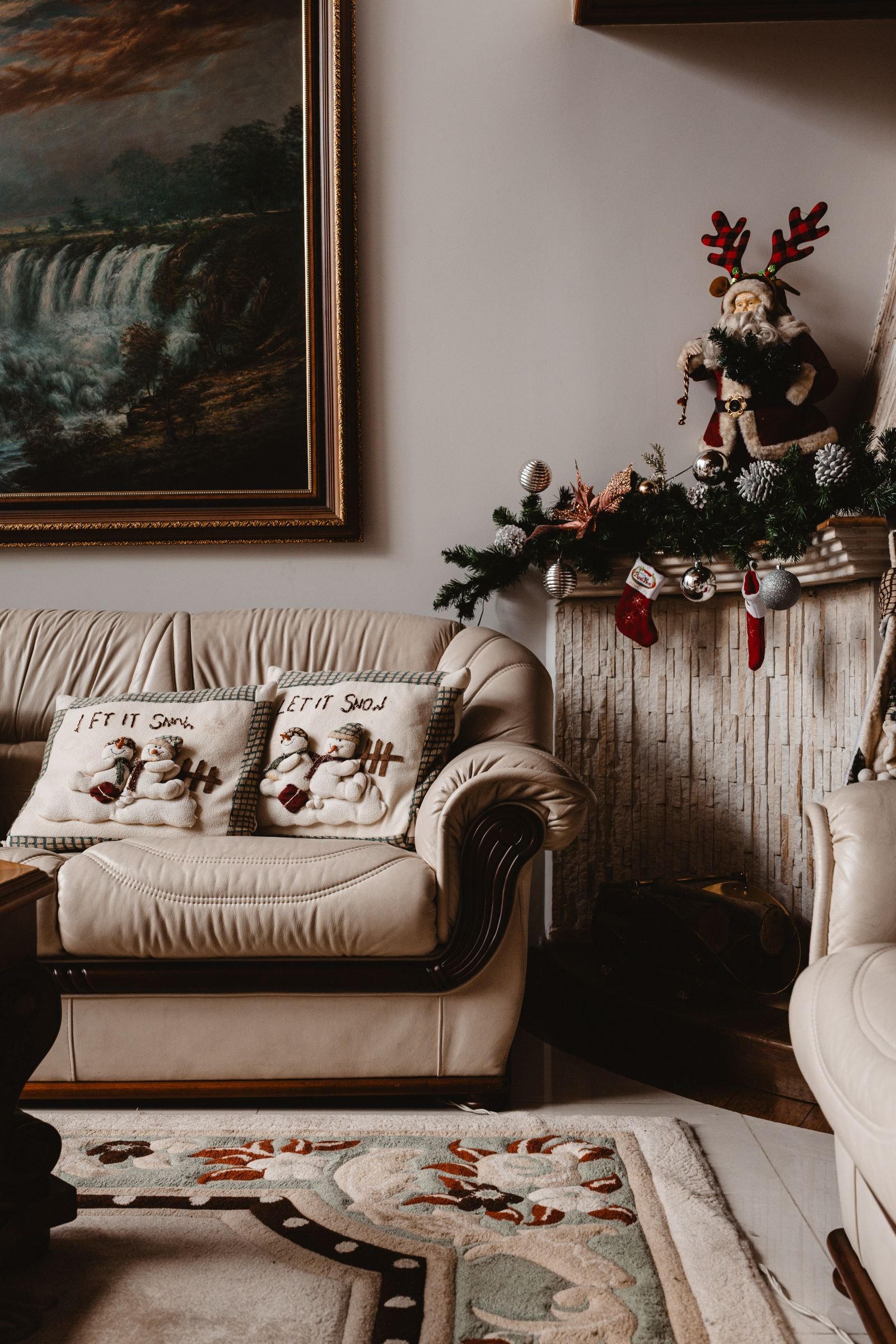 Cozy living room with a fireplace and Christmas pillows for festive holiday touches