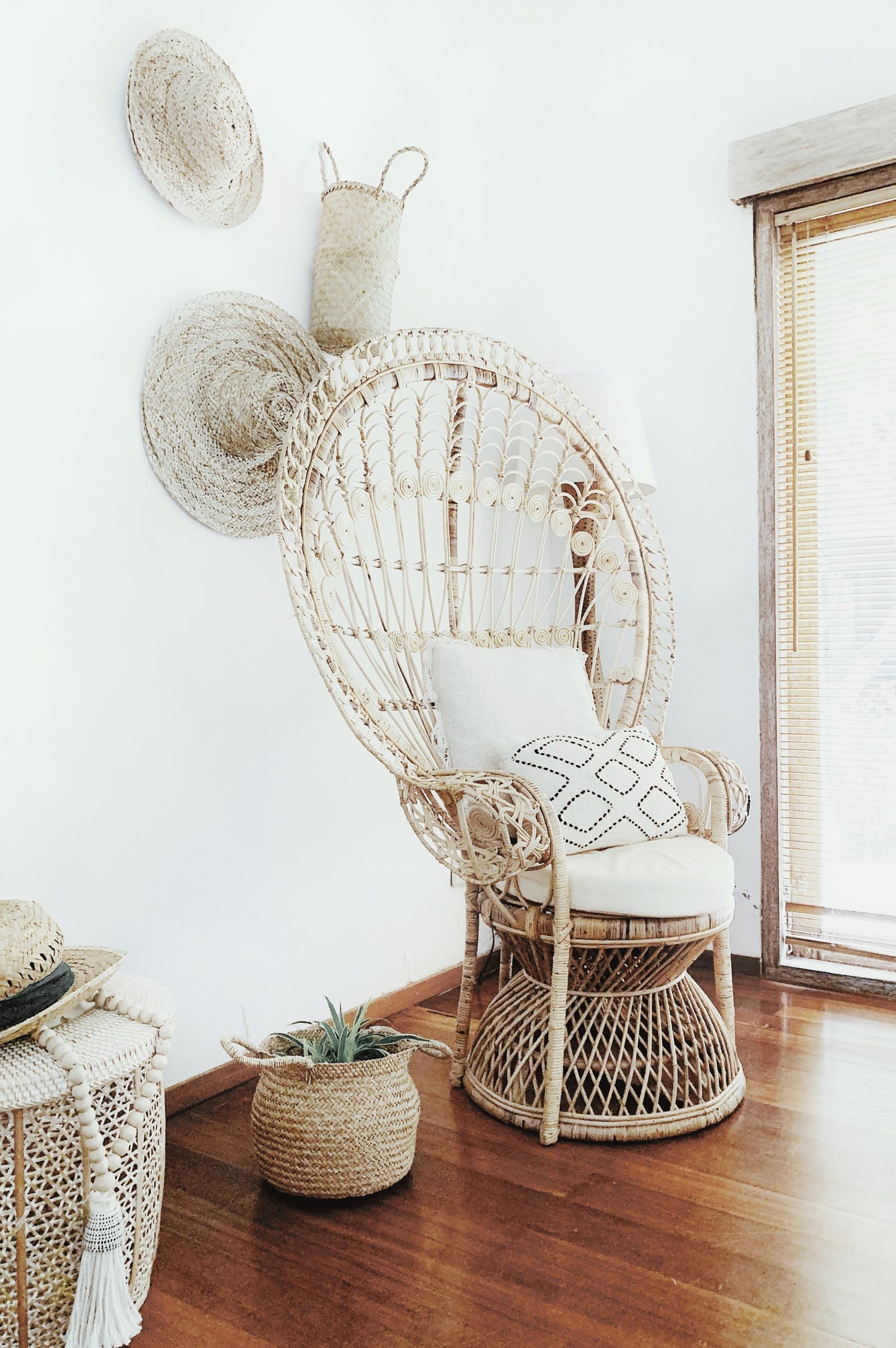 Wicker armchair in a living room with earthy tones and natural textures