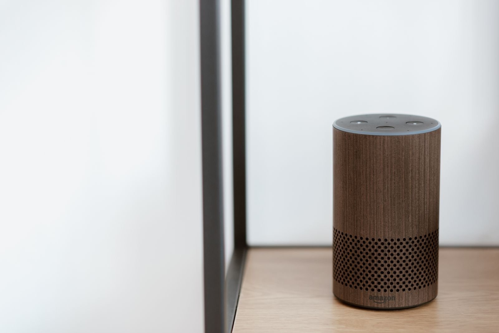 Smart speaker on a wooden shelf for hands-free voice control at home