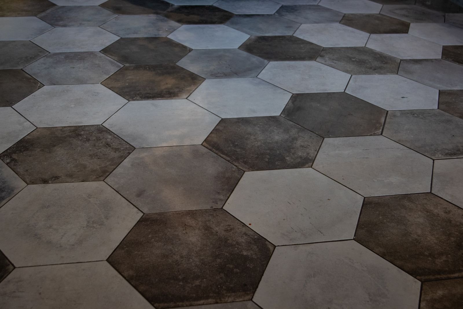 Hexagonal marble-look floor tiles with a polished finish