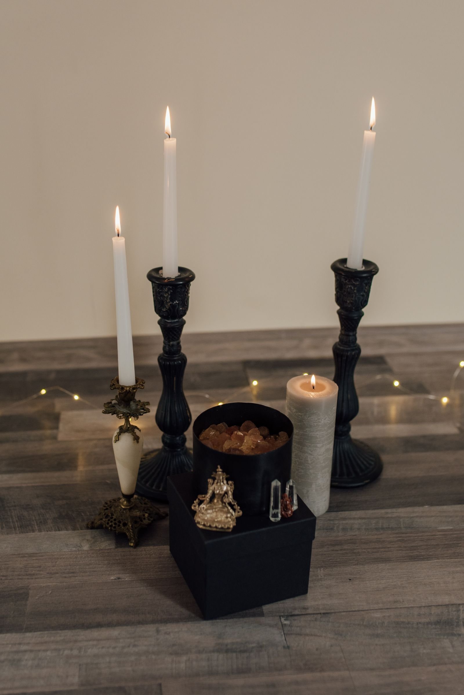 Tall candlesticks and a pillar candle burning with a warm, serene glow