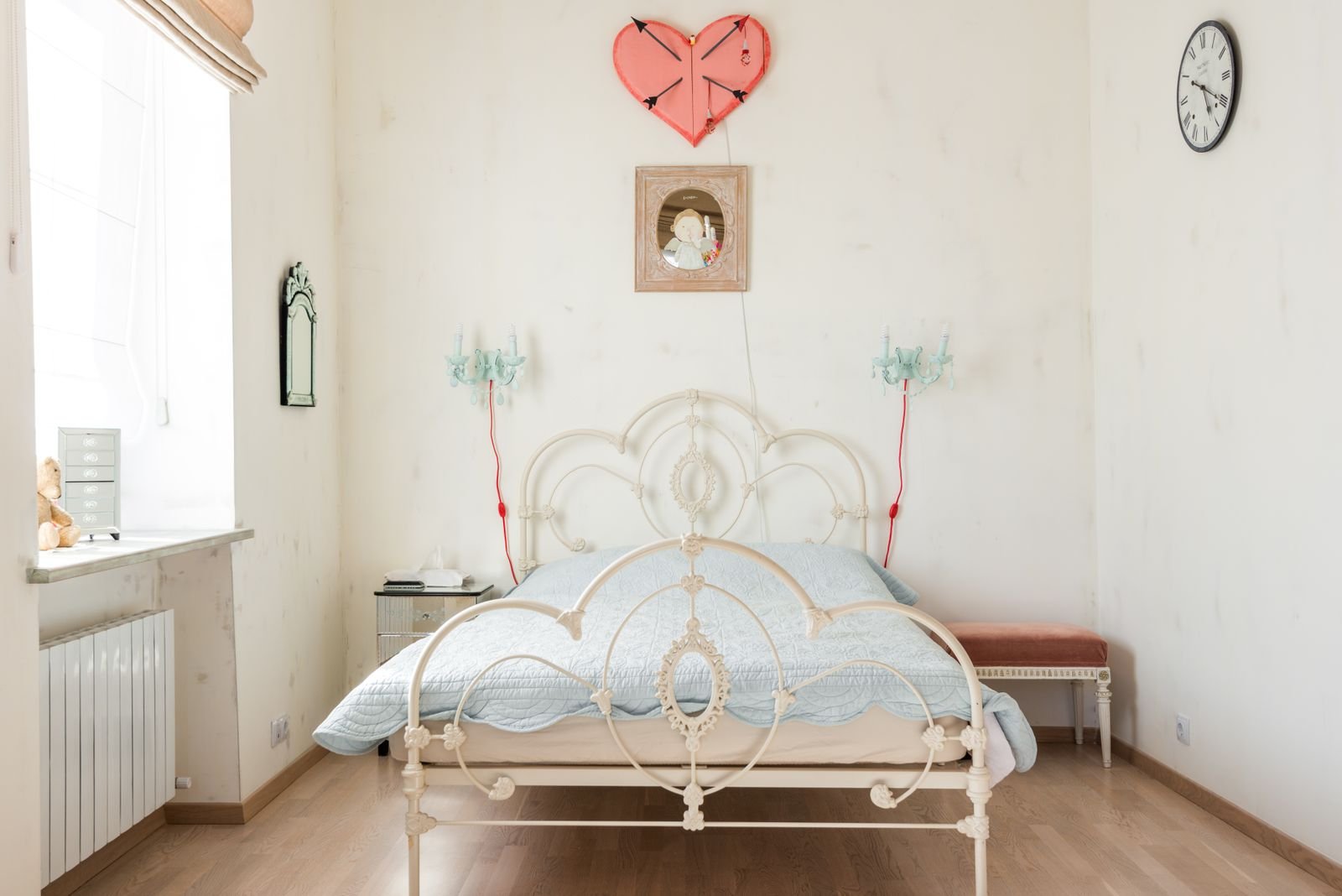 Vintage bedroom with an iron bed in soft pastel tones