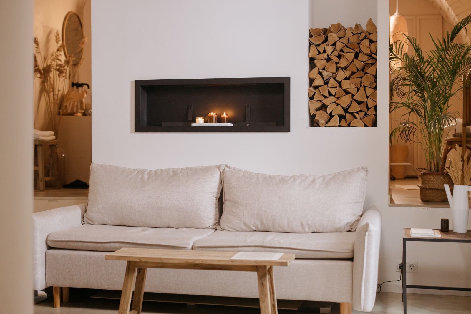 Minimalist living room with a white sofa and candles showing furnishings alongside decor