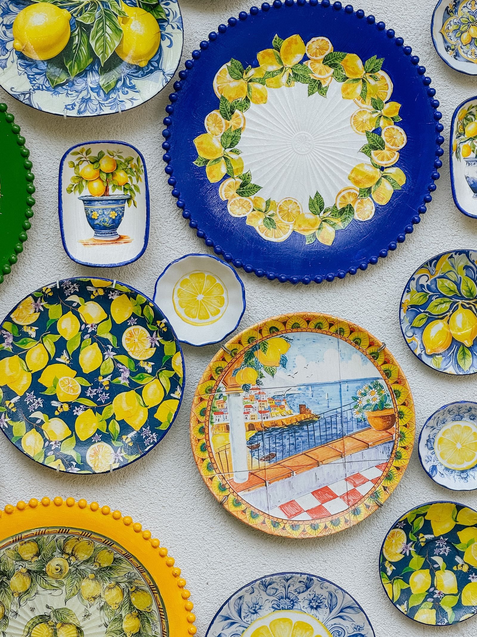 Lemon-patterned ceramic plates hung as bright, food-inspired wall decor