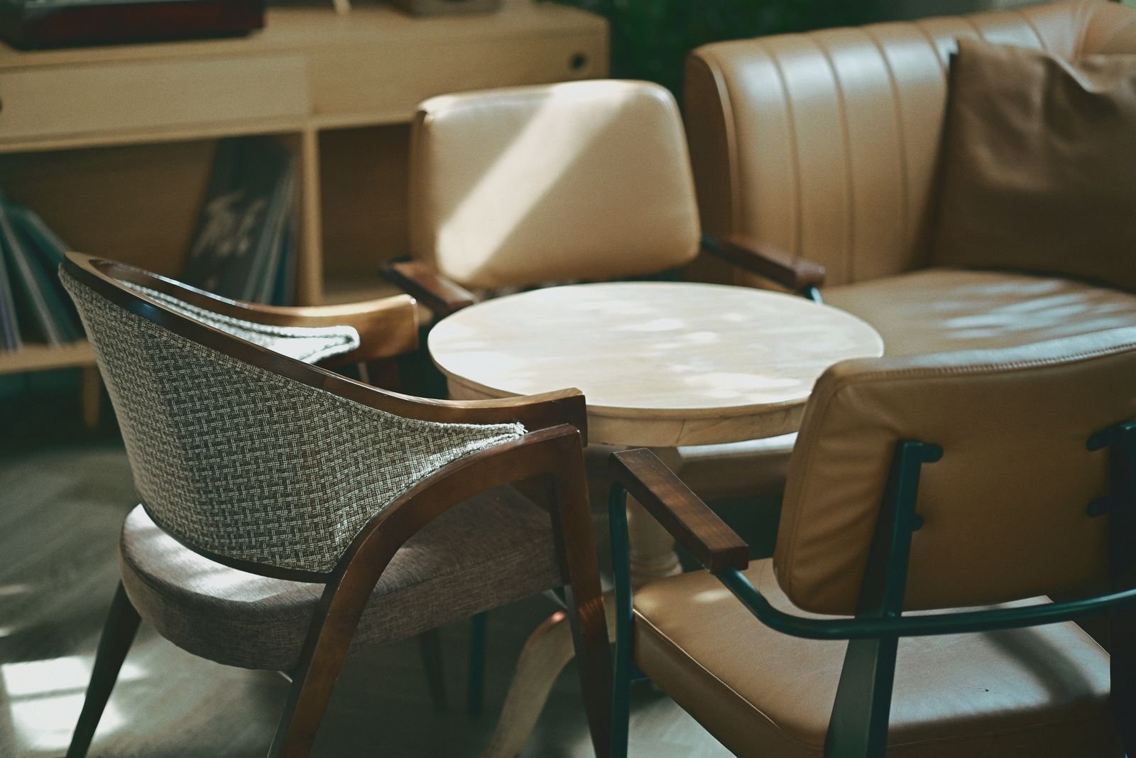Mid-century modern living room with a sofa and chairs in warm sunlight