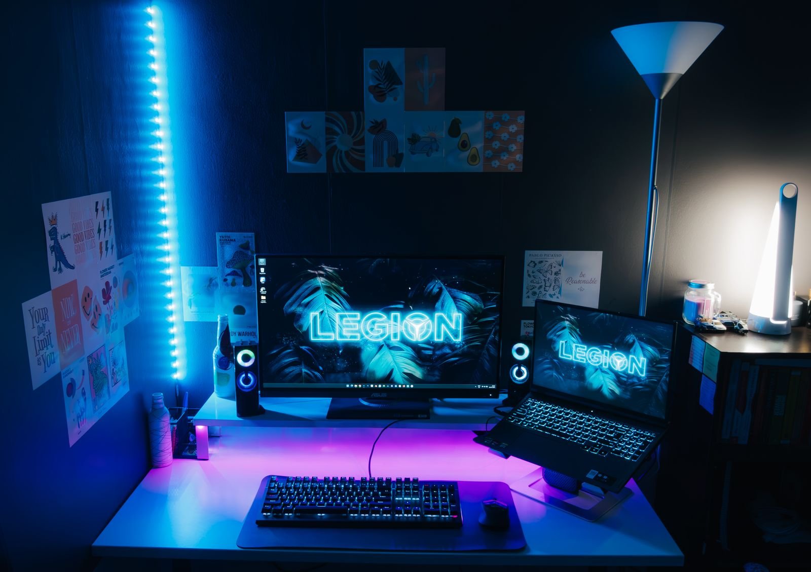 Dual-monitor desk setup lit by blue LED lights.