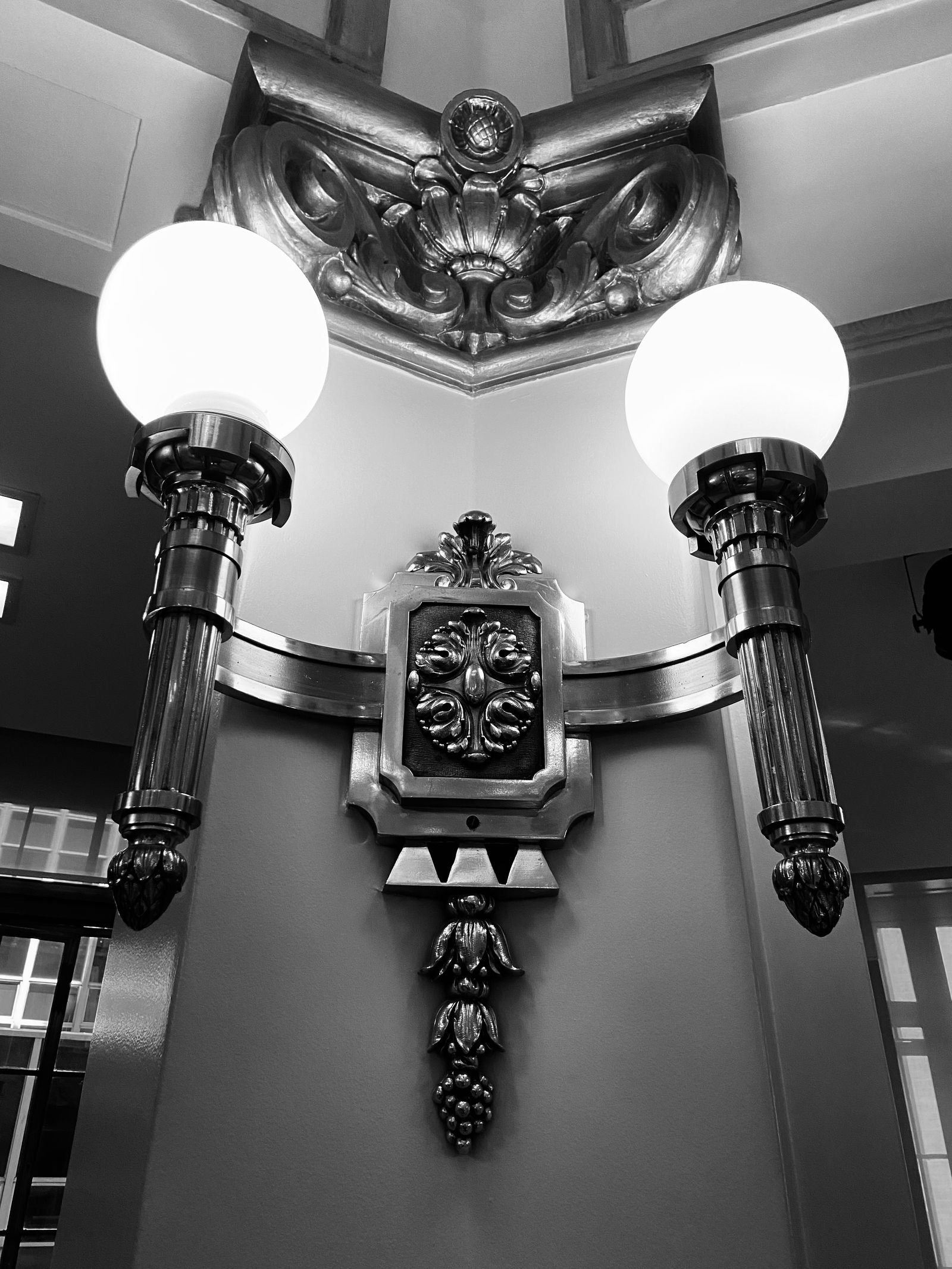 Black and white photo of an Art Deco metal wall sconce.