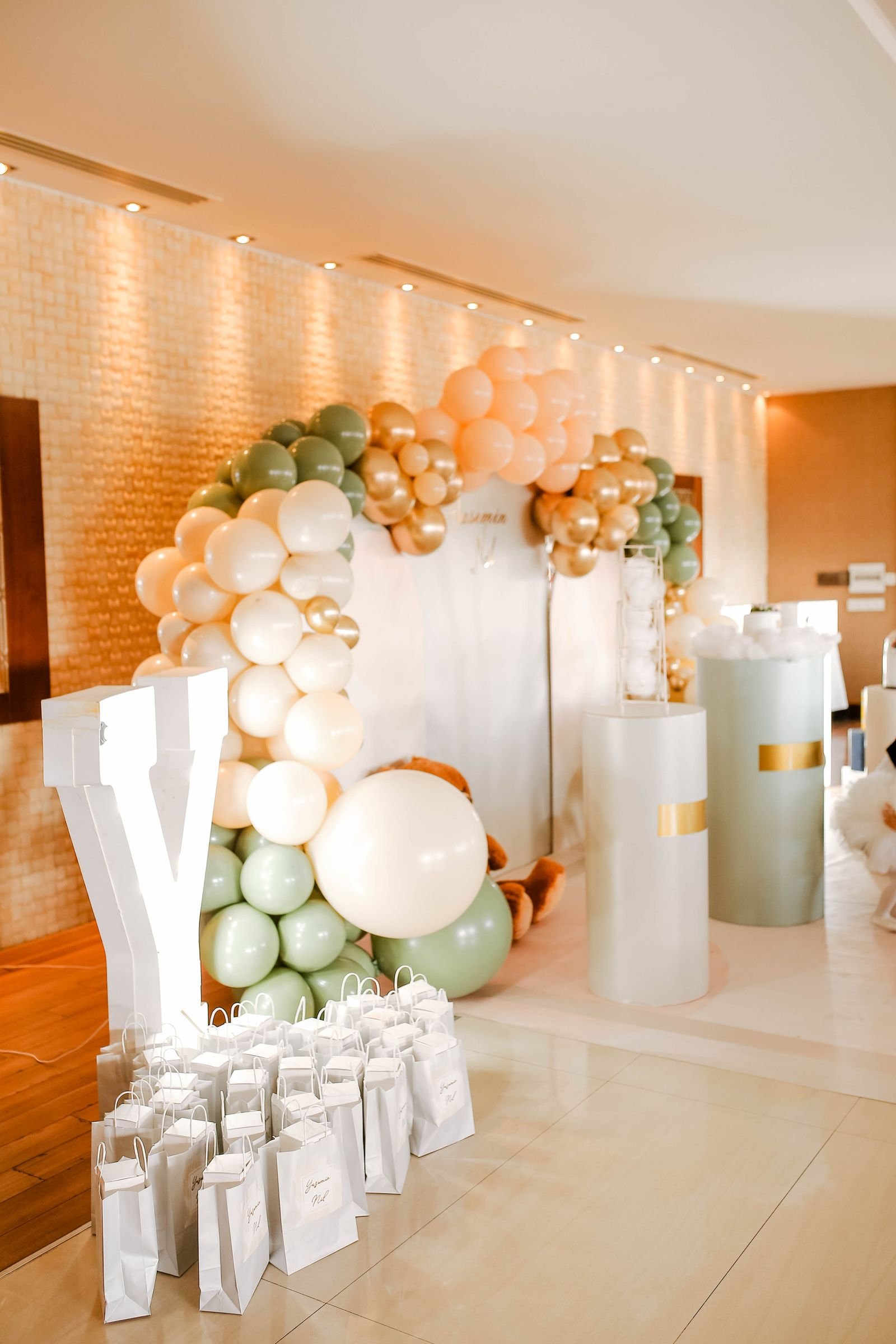 Balloon arch with gift bags set up for a party.