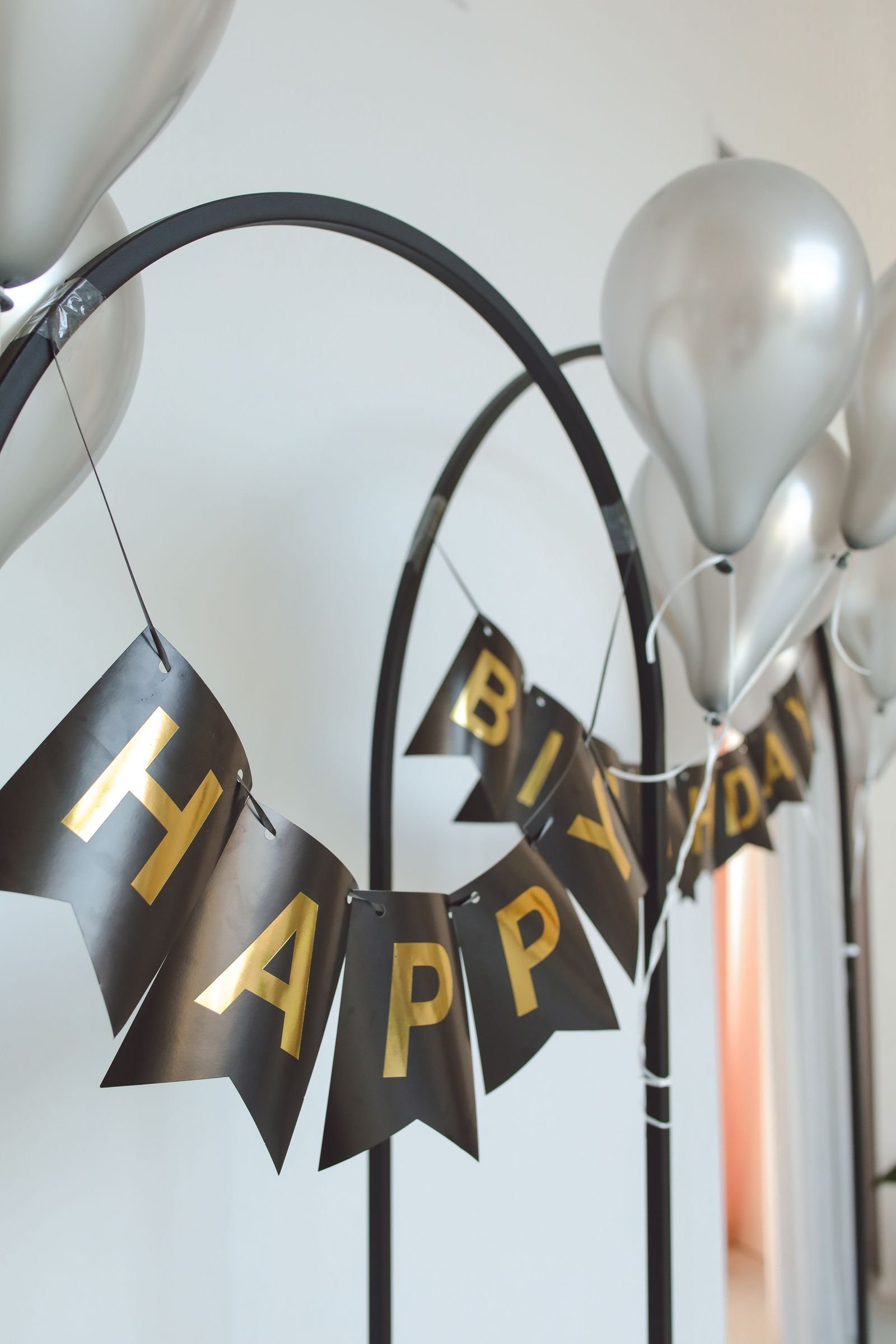 Silver balloons with a Happy Birthday banner.