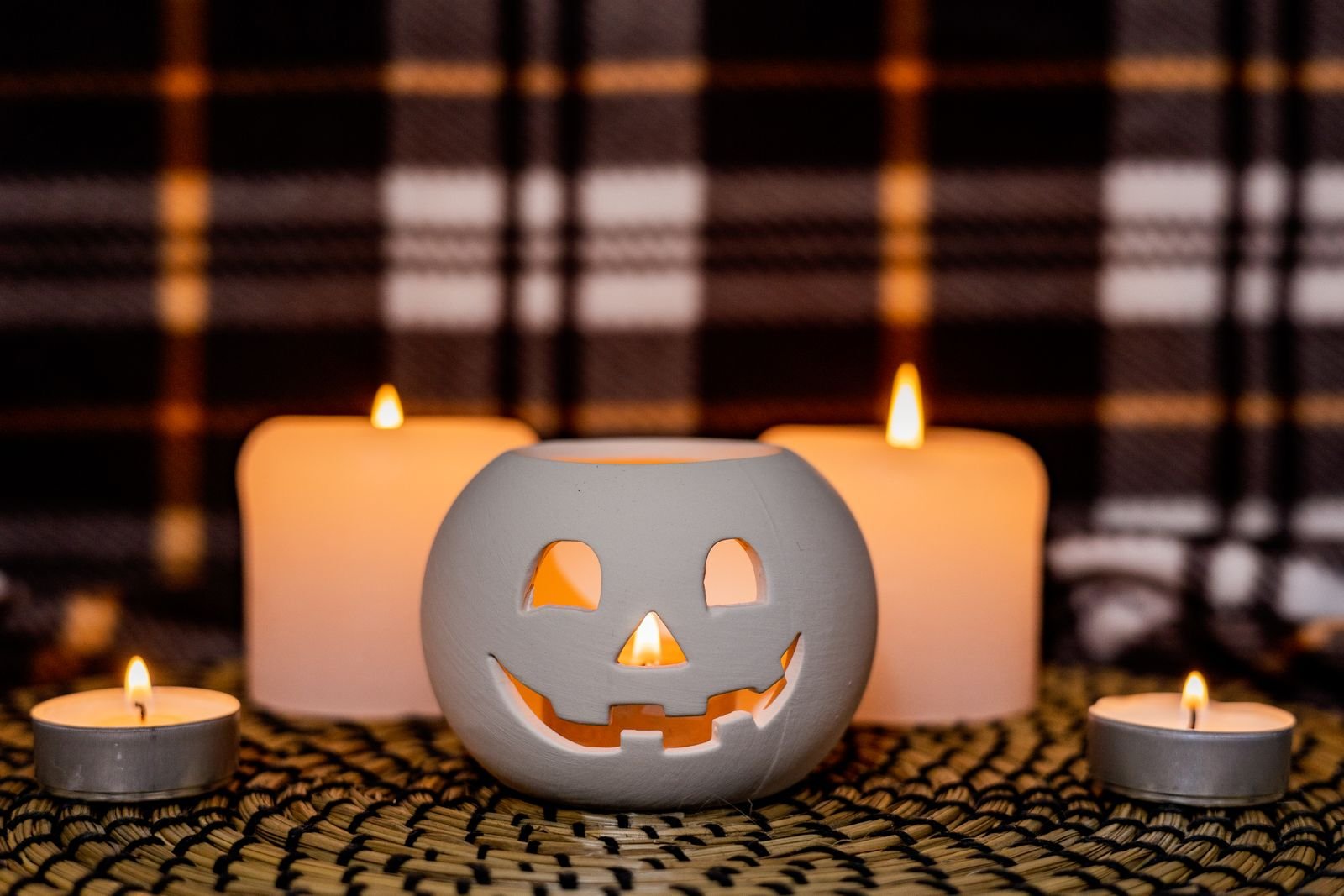 Carved jack-o'-lantern surrounded by lit candles