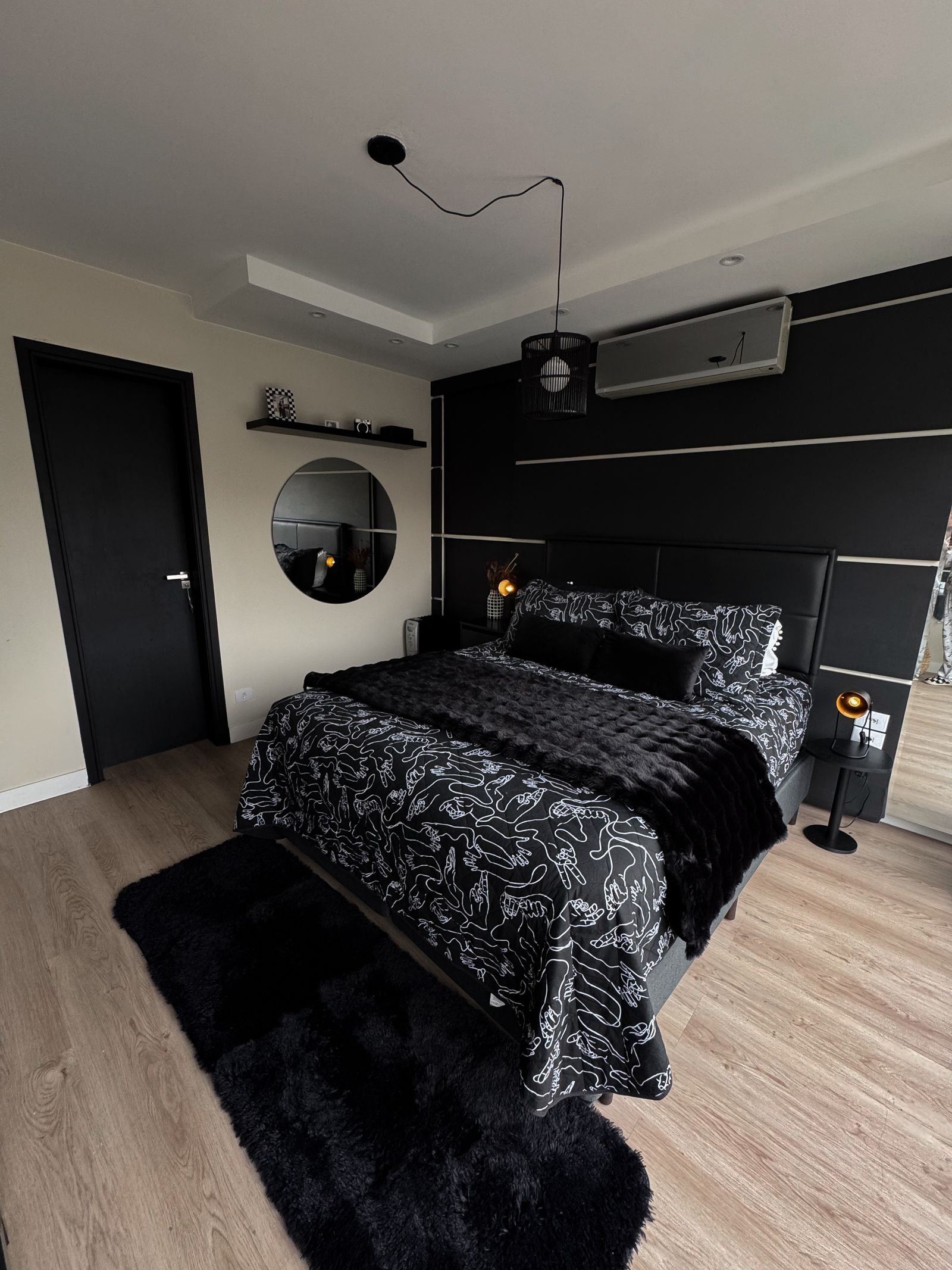 Black-themed bedroom with modern decor and chic details.