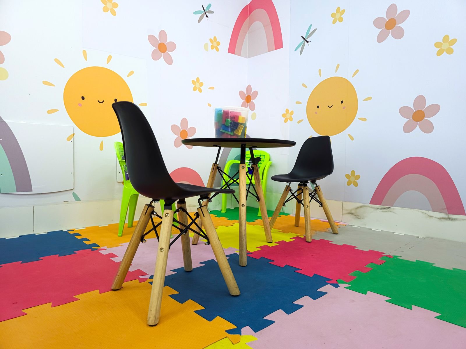 Colorful children's playroom with sun and rainbow wall art.