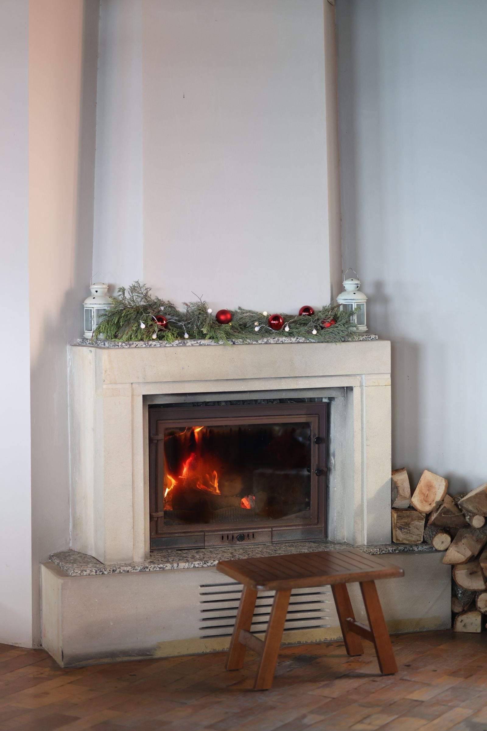 Fireplace decorated for the holidays in a warm, cozy room.
