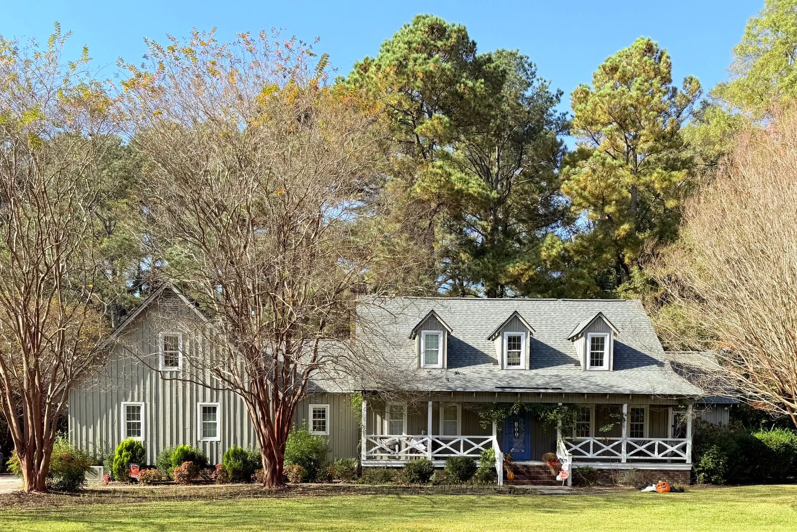 Ranch-style house surrounded by autumn trees.