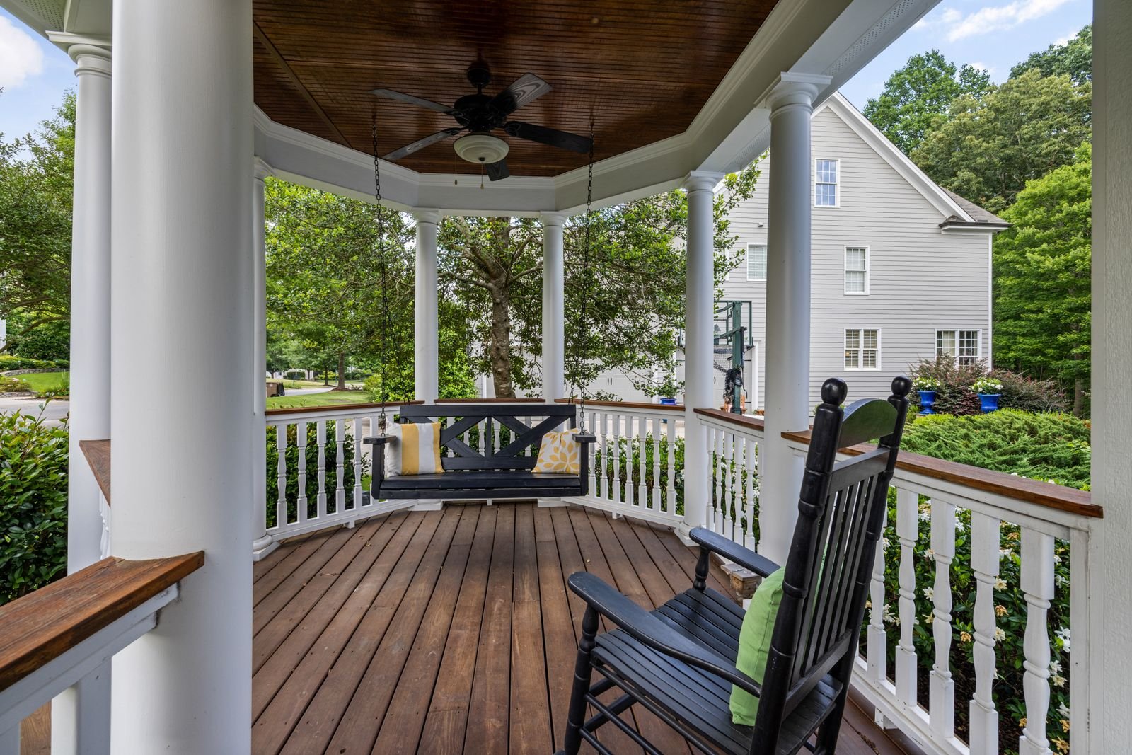 Porch with a rocking chair and a swing.