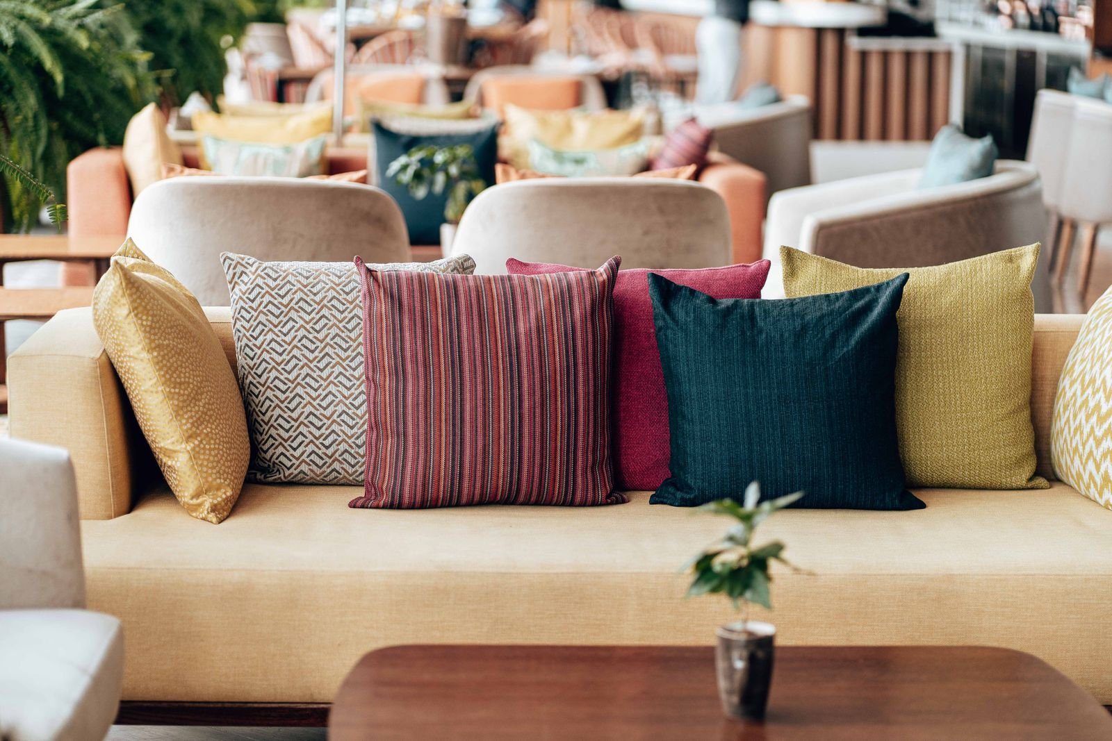 Vibrant throw pillows on a yellow sofa in a stylish seating area.