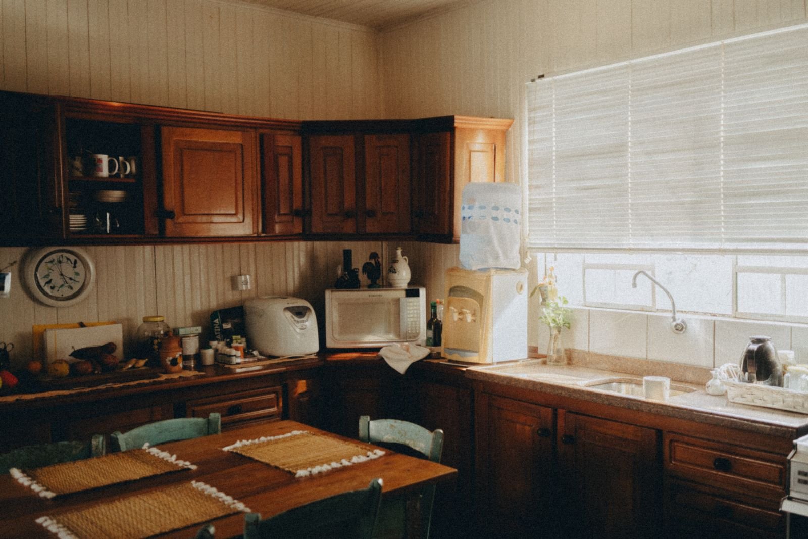 Rustic kitchen with wooden cabinets and soft natural light.