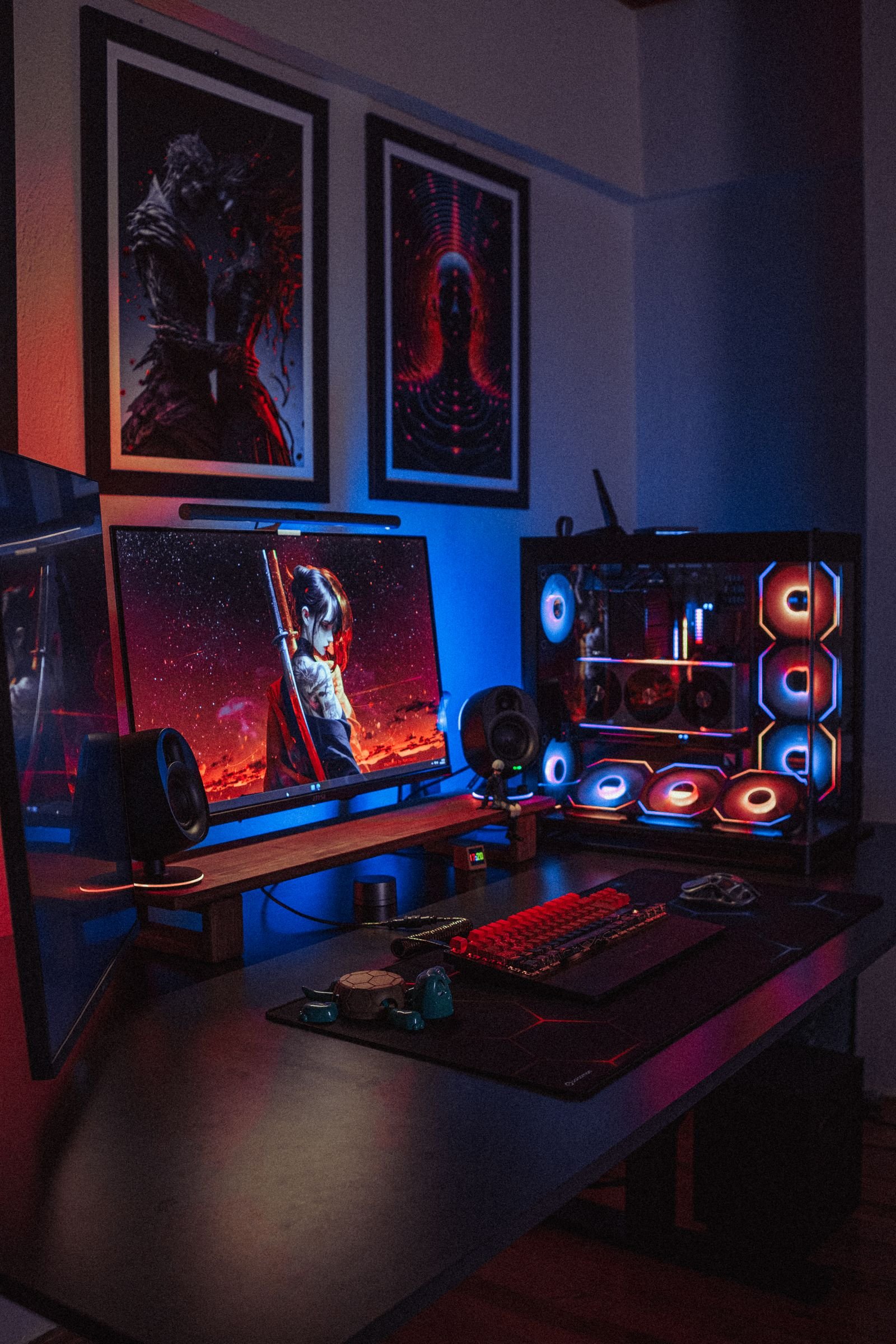 RGB gaming setup with dual monitors and a backlit keyboard in a dim room.