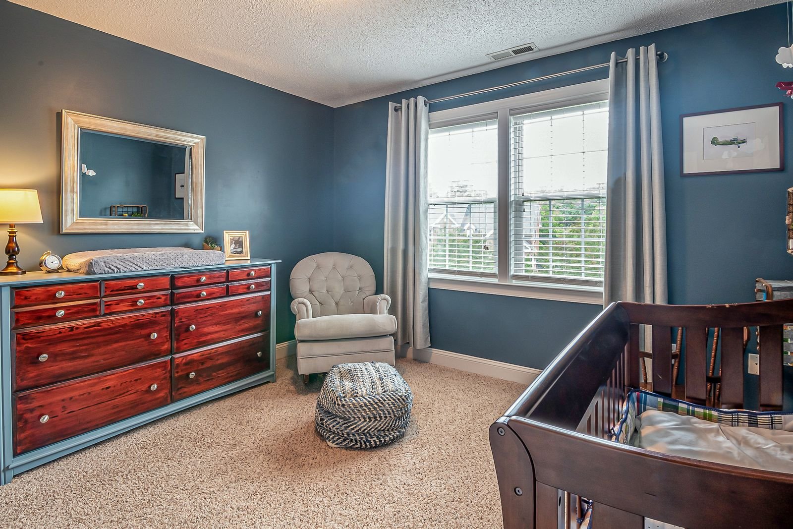 Baby room with a cozy armchair in the corner.