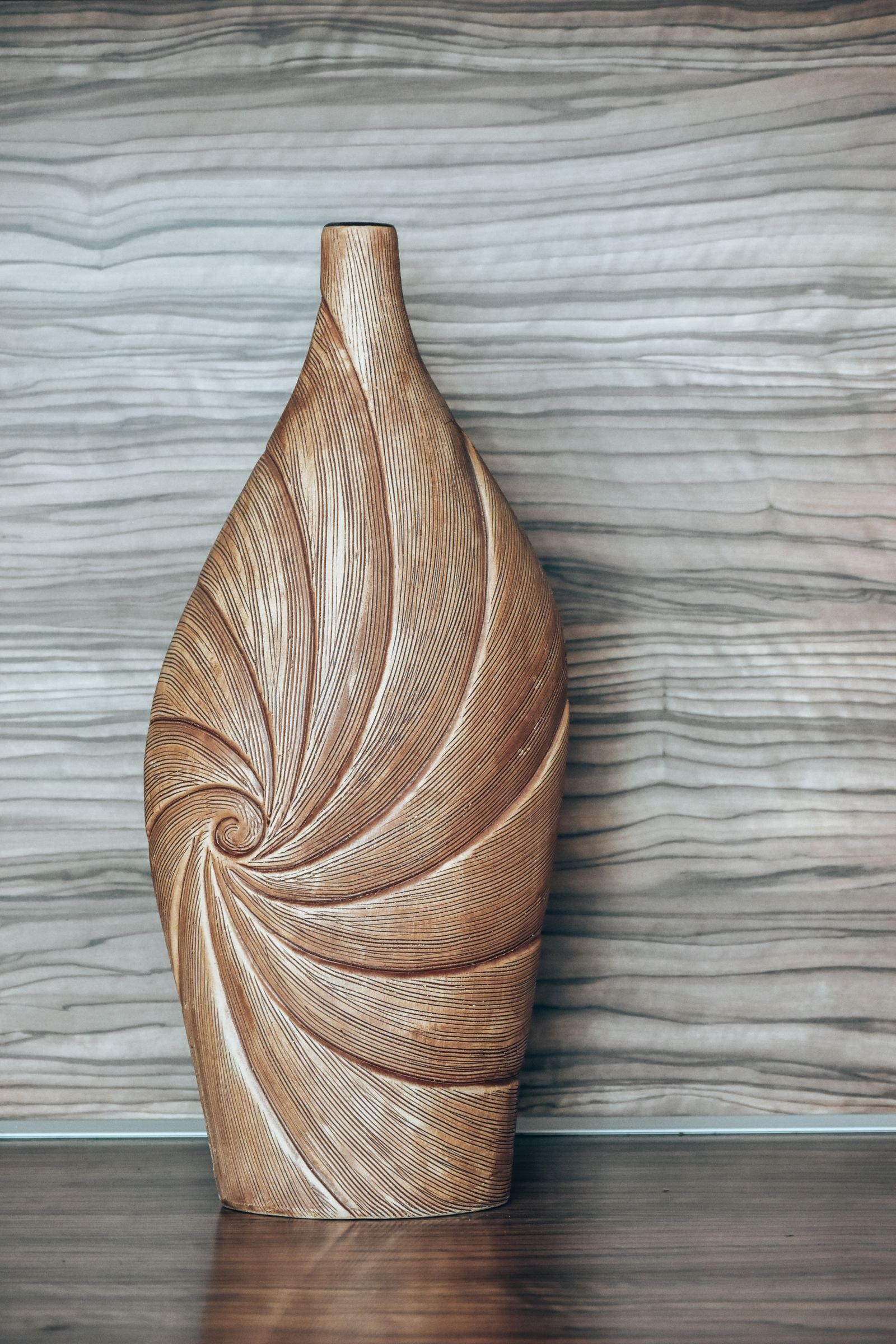 Wooden vase with a spiral design.