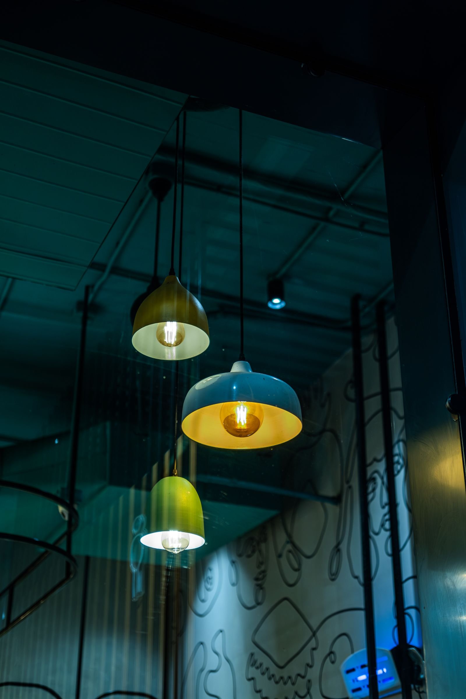 Three pendant lights casting a warm glow in a modern interior.