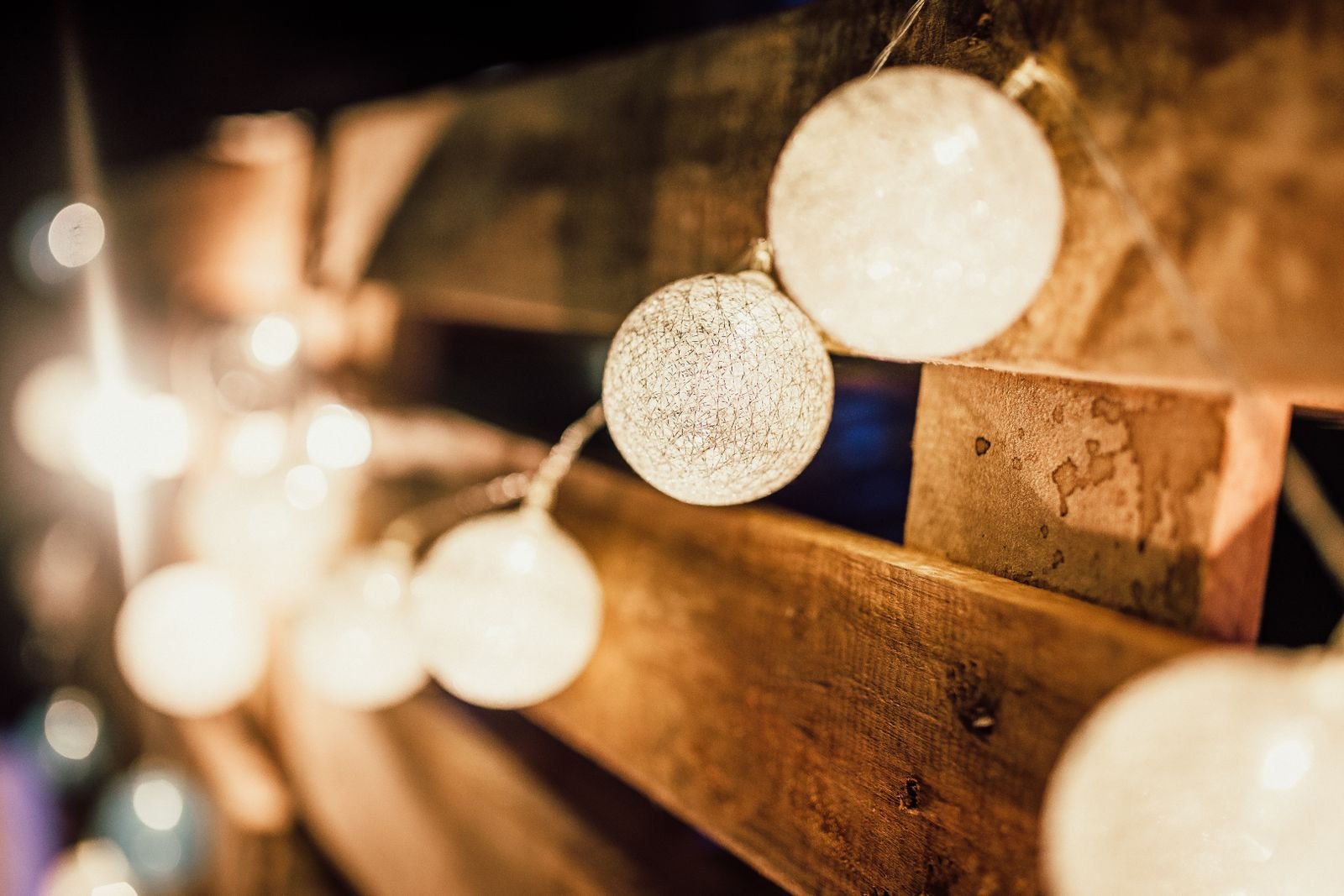 String lights mounted on a wooden wall for a warm, cozy glow.