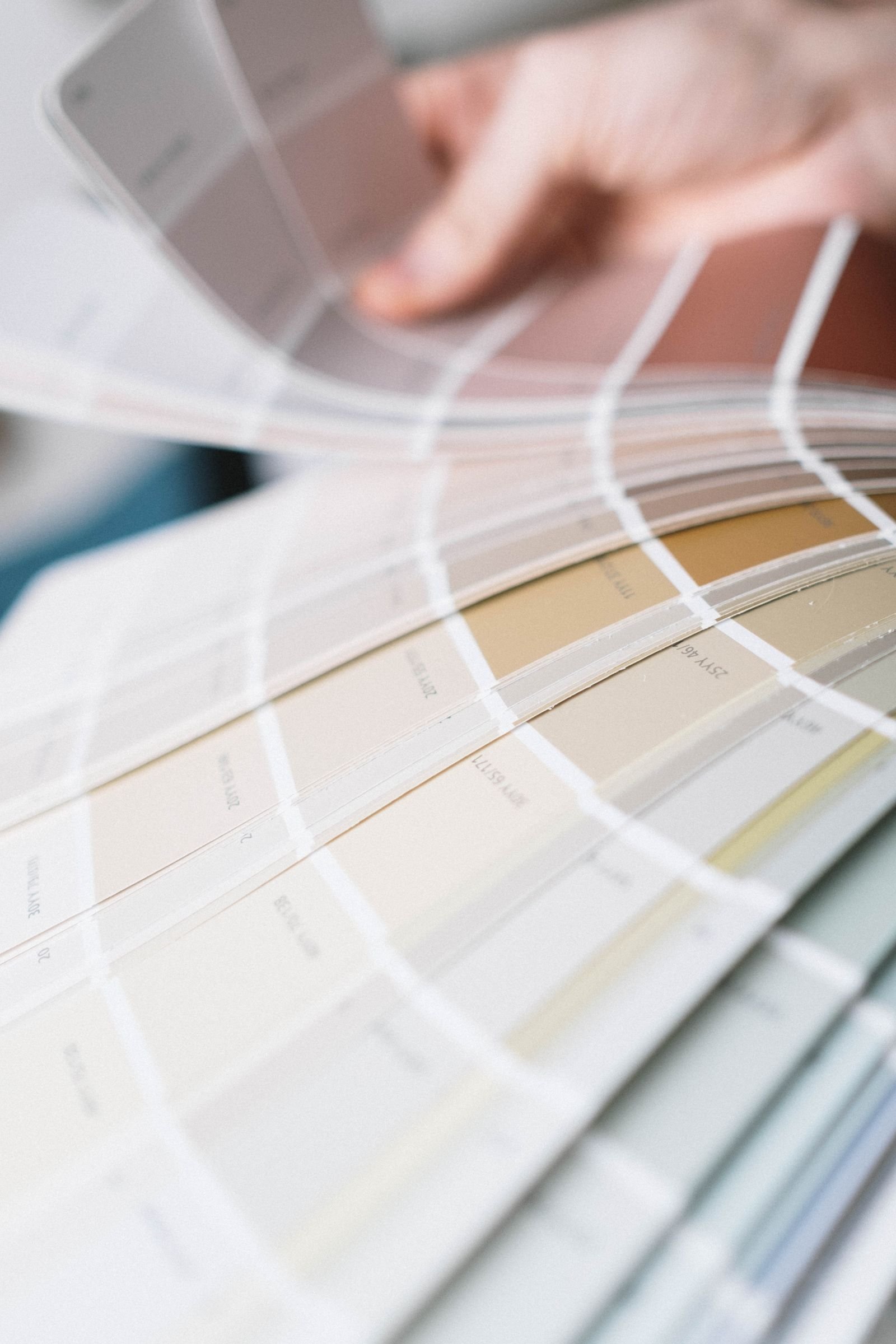 Fan of paint color swatches used to choose an interior color scheme.