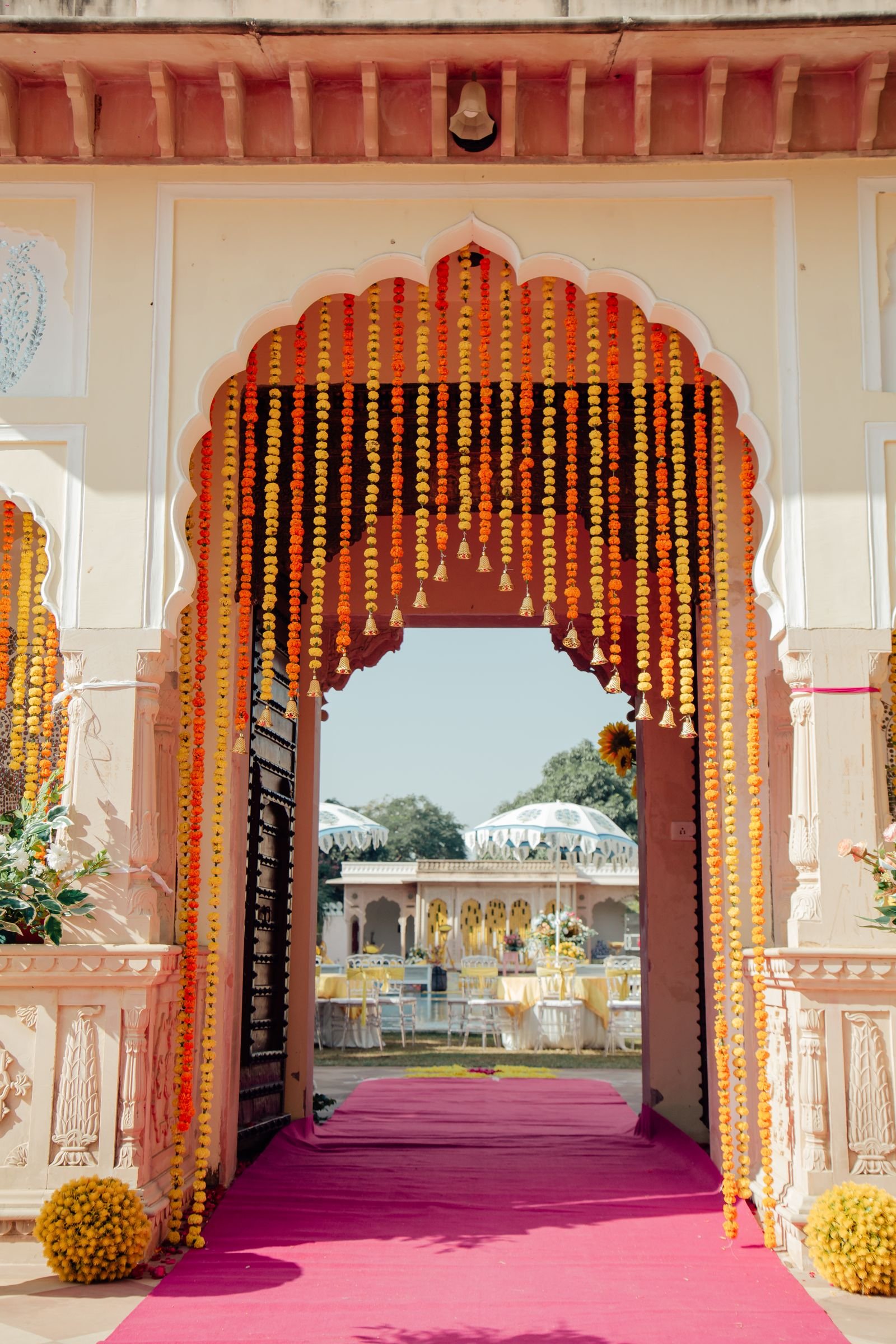 Archway decorated with yellow marigold garlands.