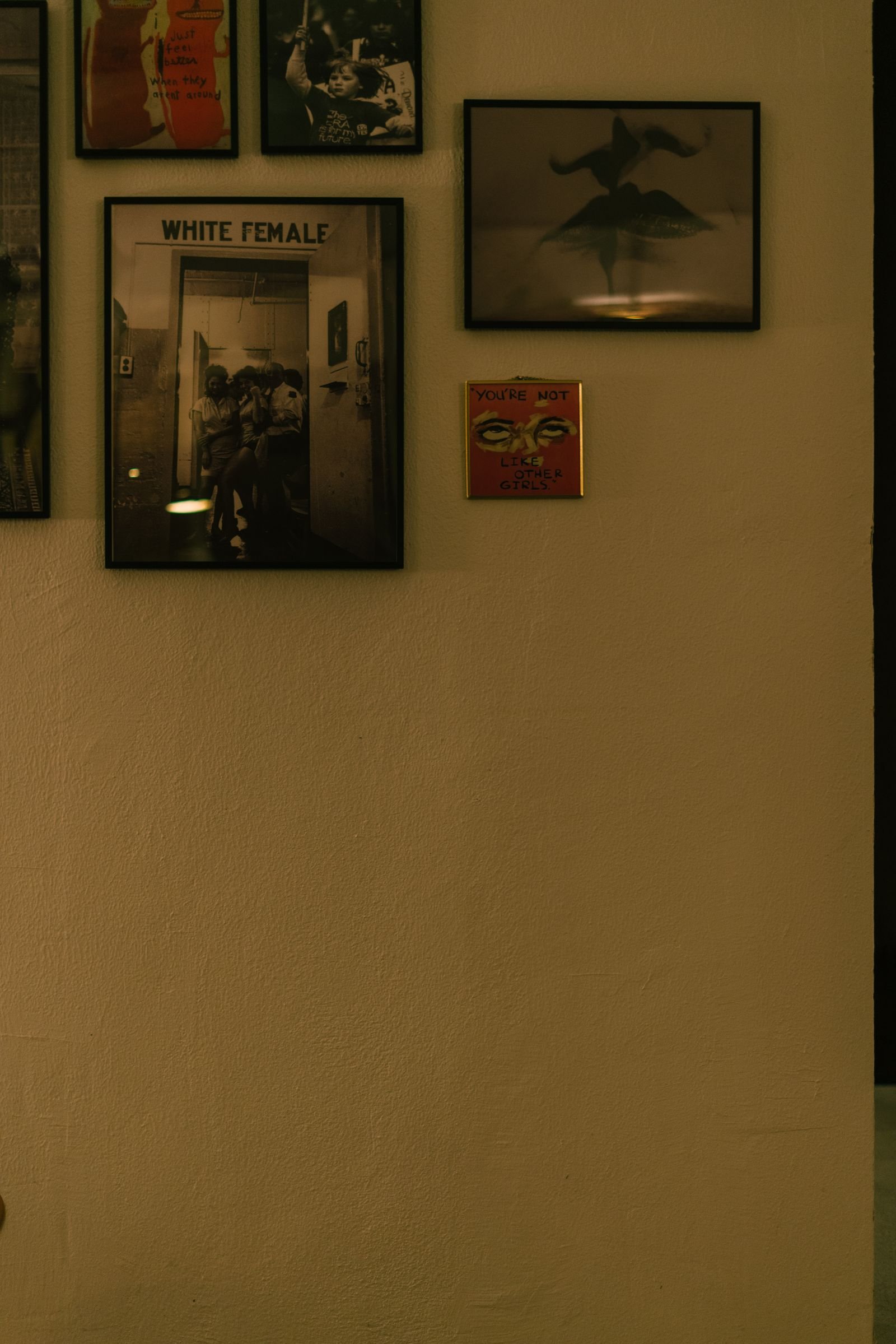 Wall of mixed framed photos and artworks in a cozy room