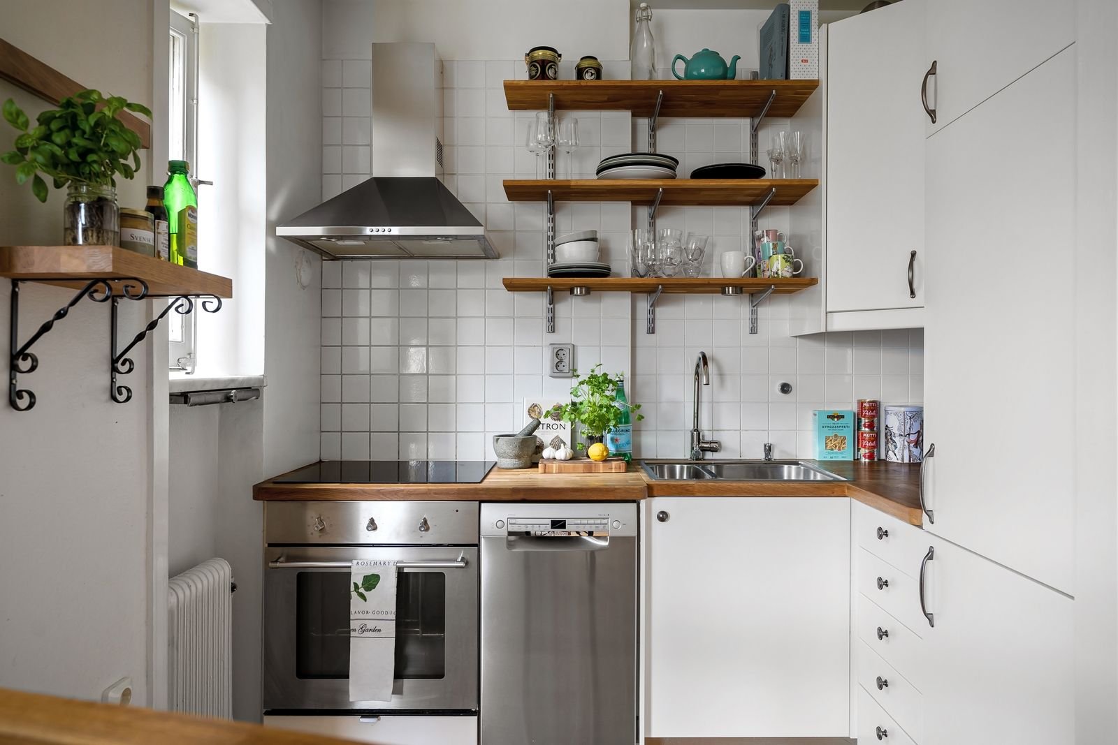 Small kitchen with white cabinets and open shelving.