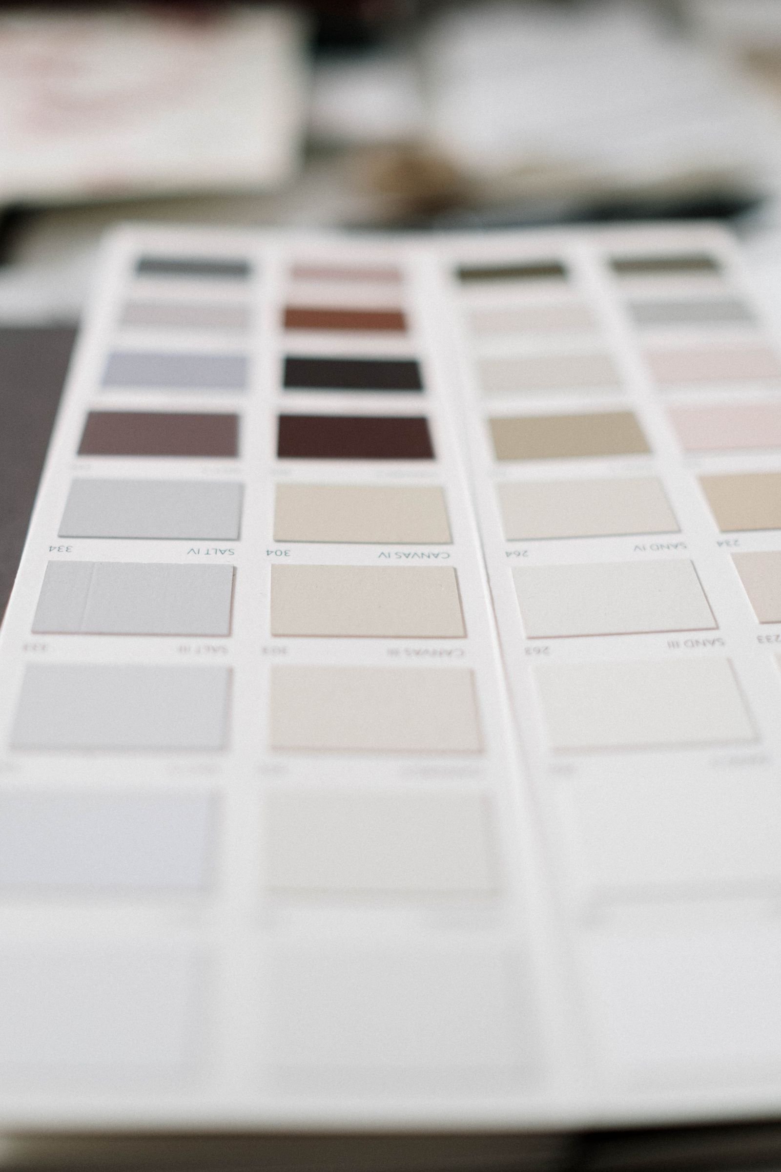 Neutral paint swatches in soft tones on a color sample sheet.