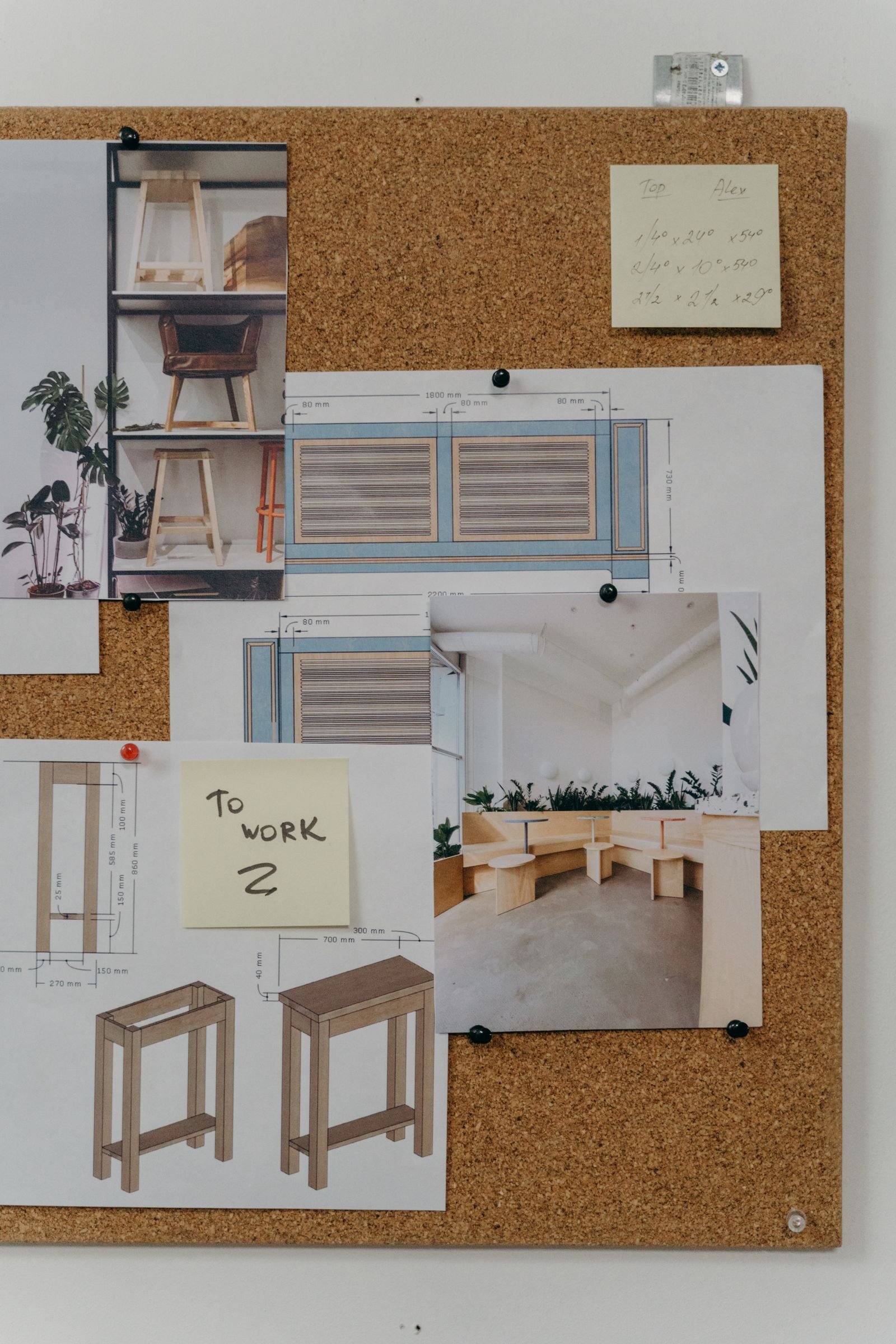 Cork board pinned with interior design sketches and inspiration photos.