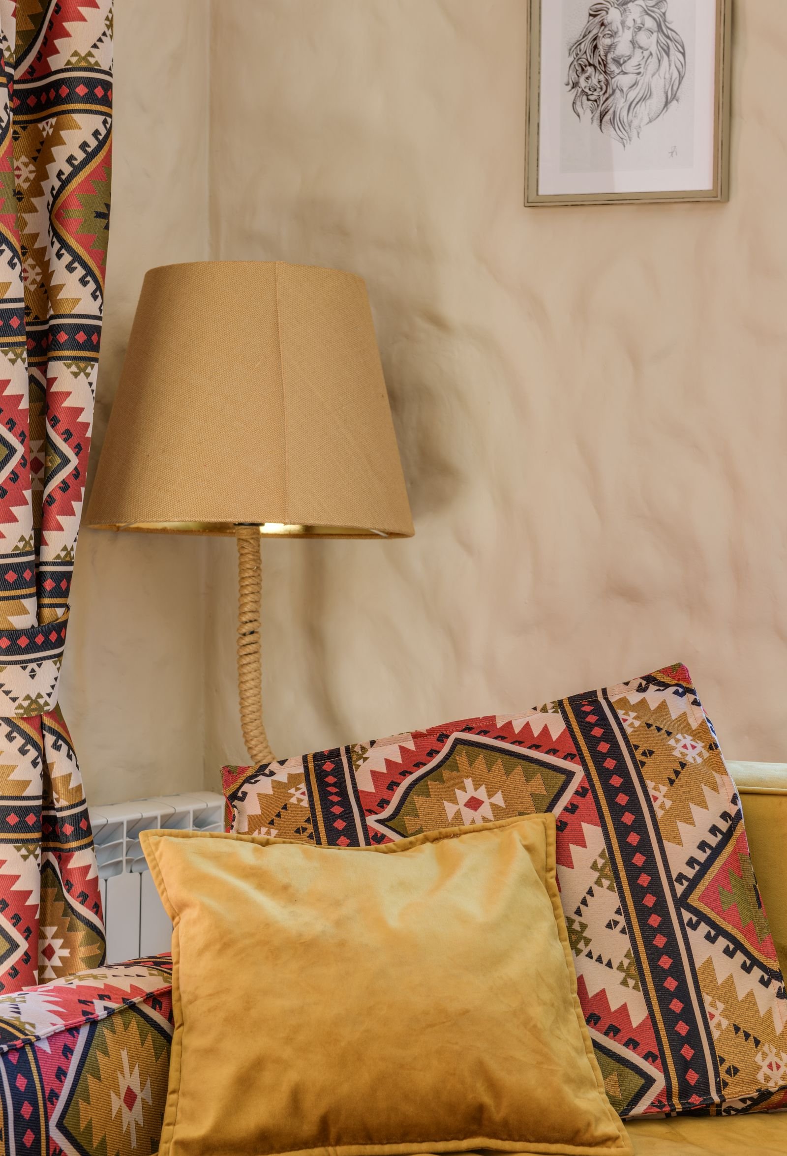 Living room with a patterned couch and throw pillows.