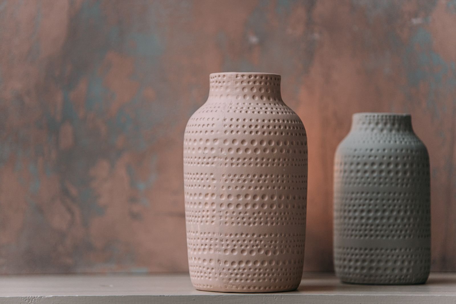Two handcrafted ceramic vases with textured patterns.