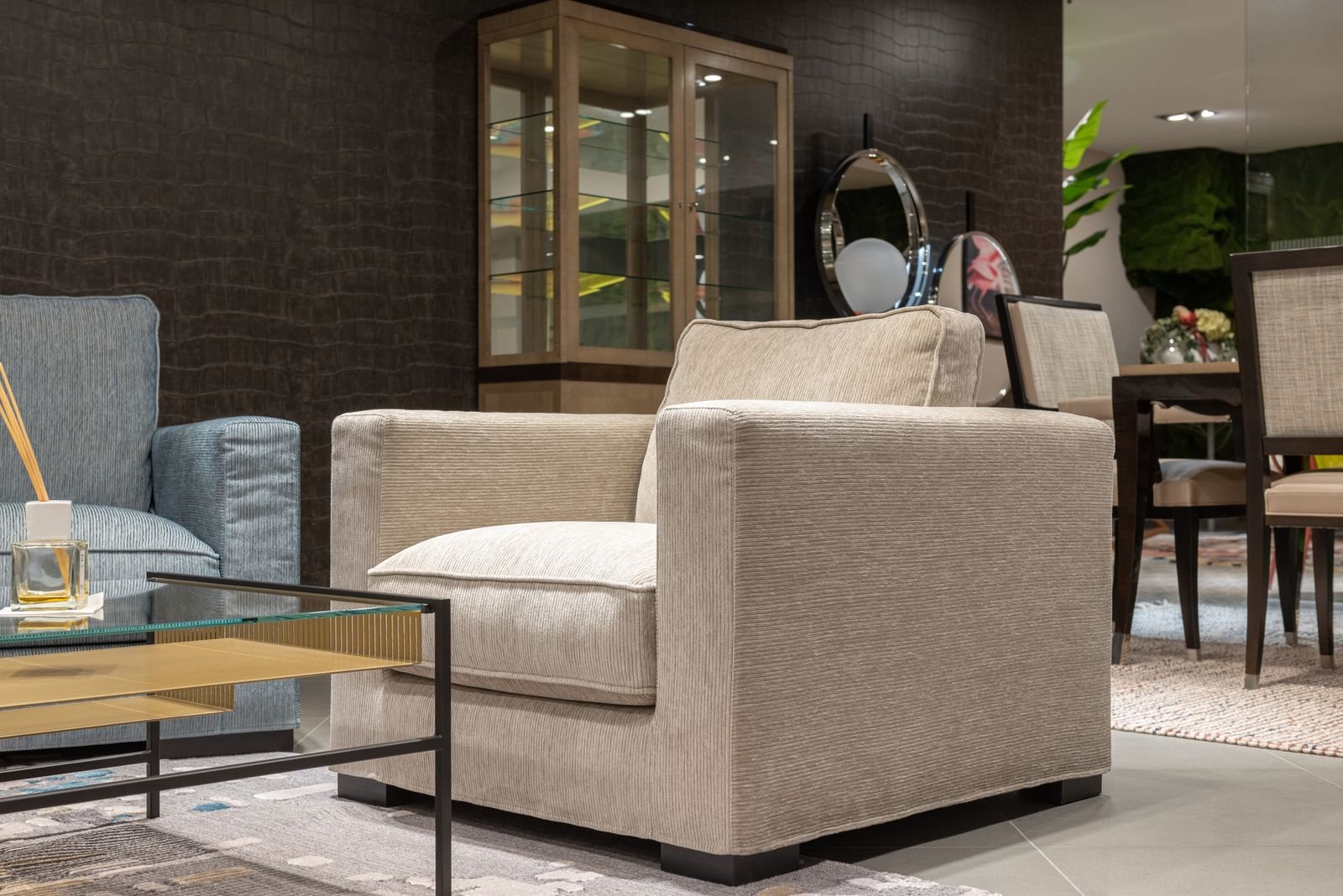 Light living room with comfortable armchairs and a glass-top table.