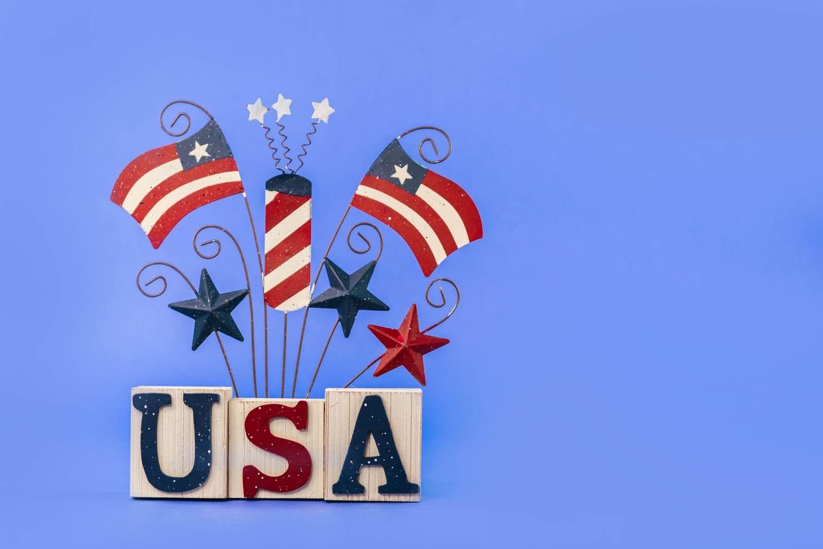 Patriotic decoration with American flag stripes and stars on a blue background.