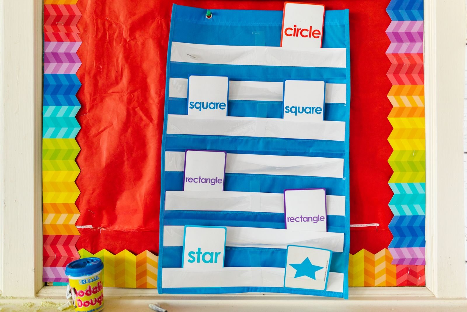 Bright classroom display with colorful geometric shapes.
