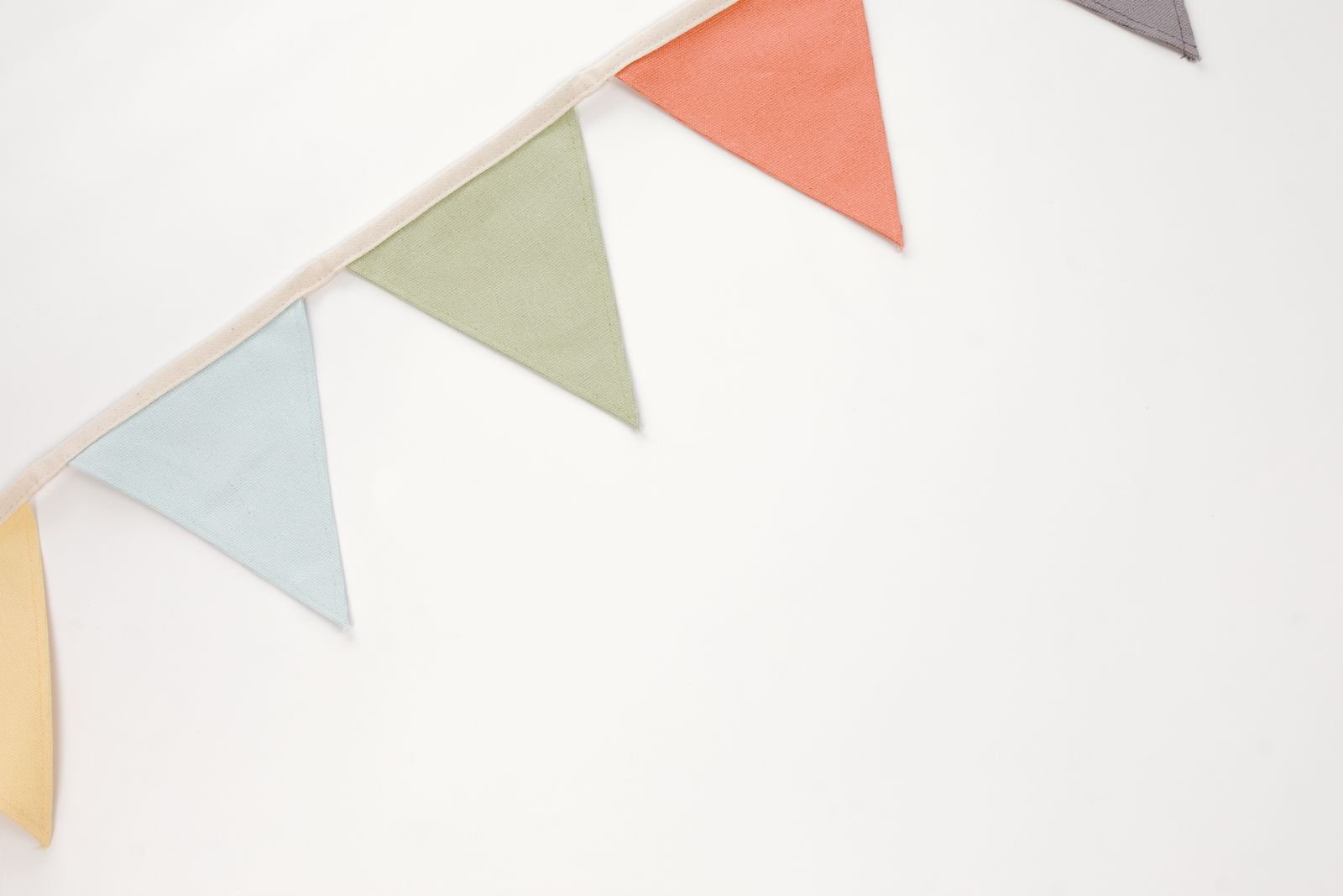 Colorful triangular bunting garland on a white background.