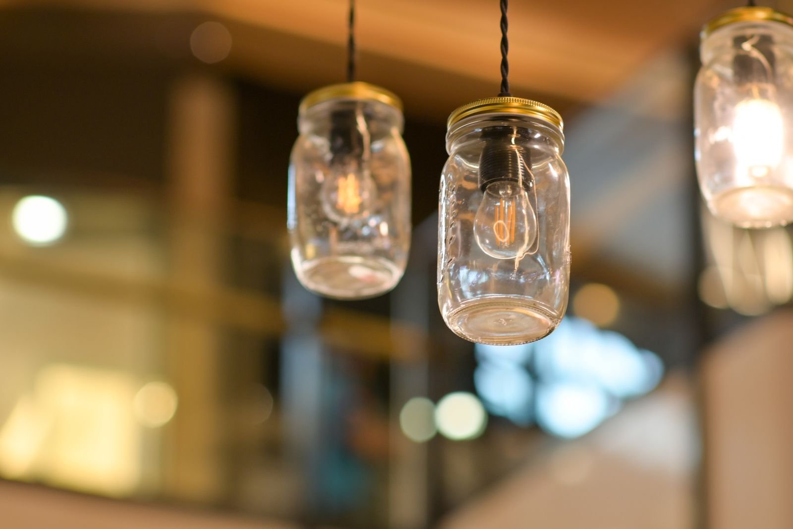 Mason jar lights hanging indoors with a warm glow.