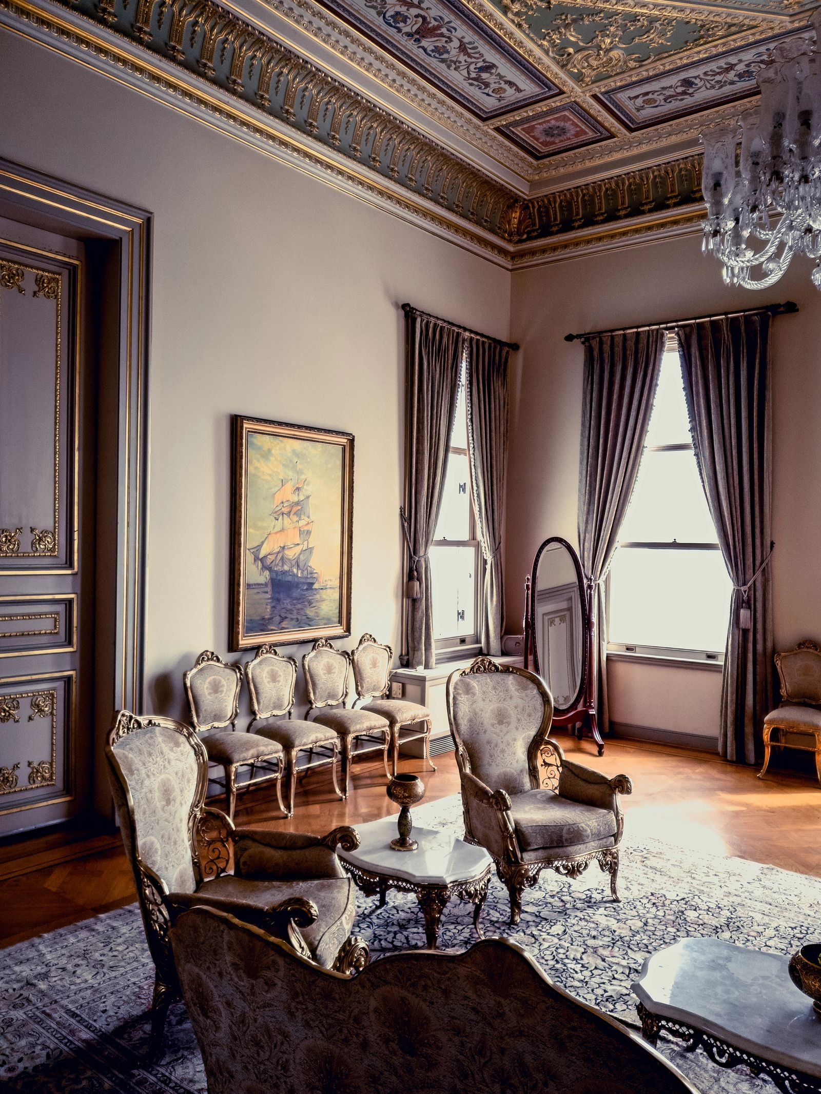 Classic living room with elegant furniture and ornate decor in natural light.
