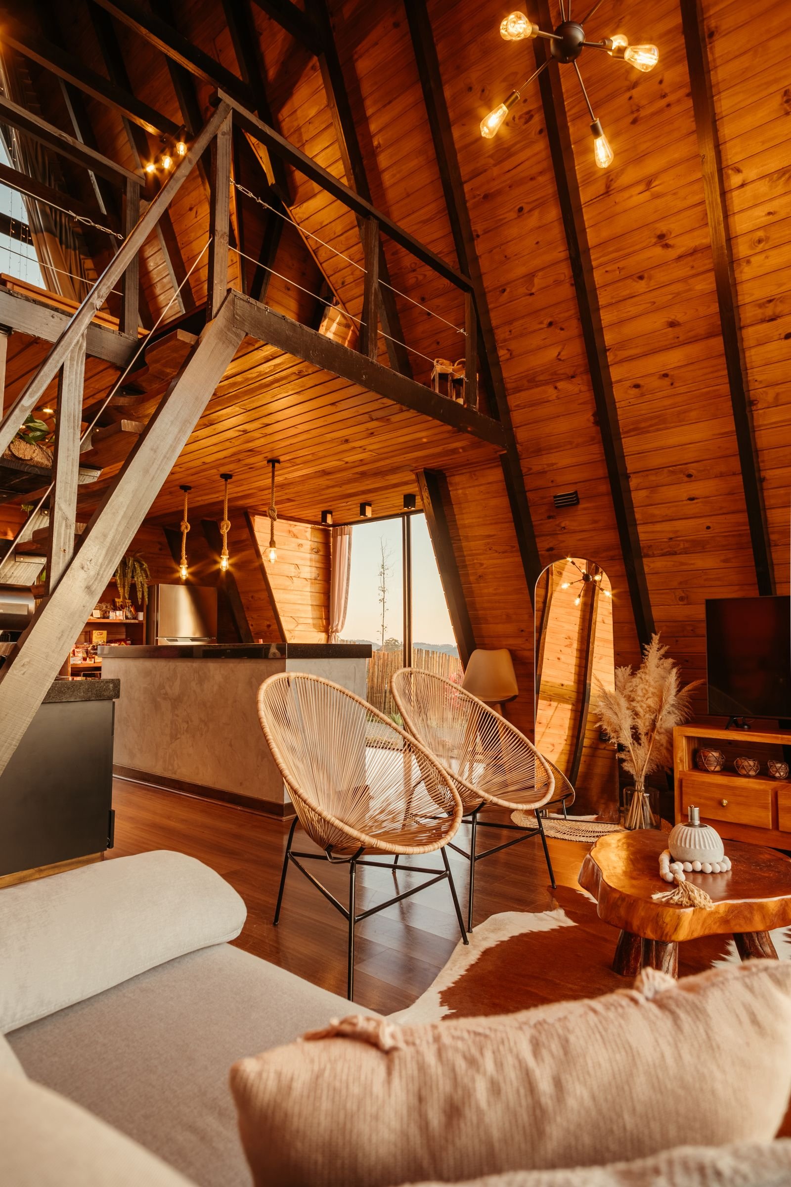 A-frame cabin living room with rustic wood decor and modern furniture.