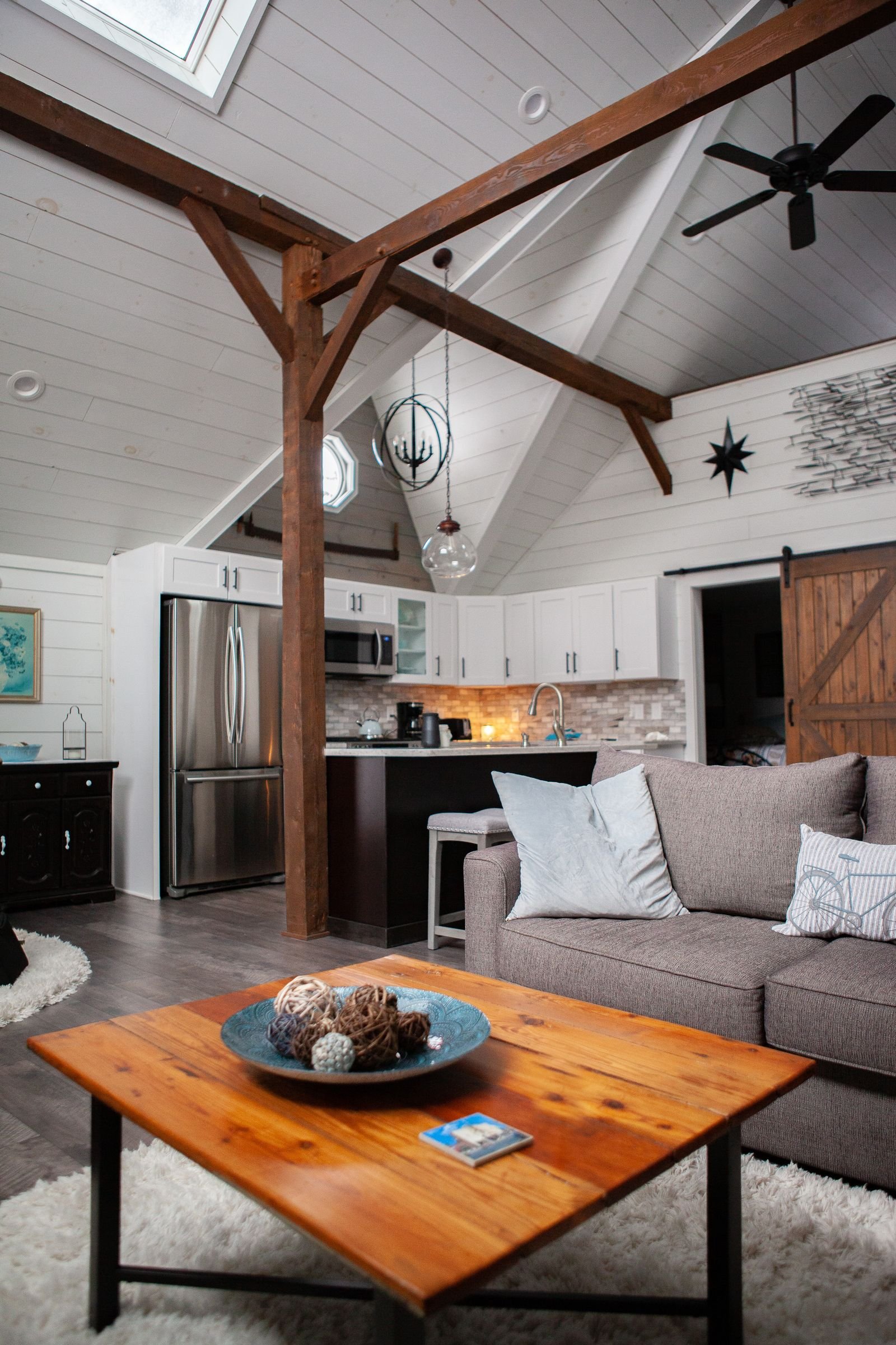 Rustic living area with wood accents and an open kitchen.