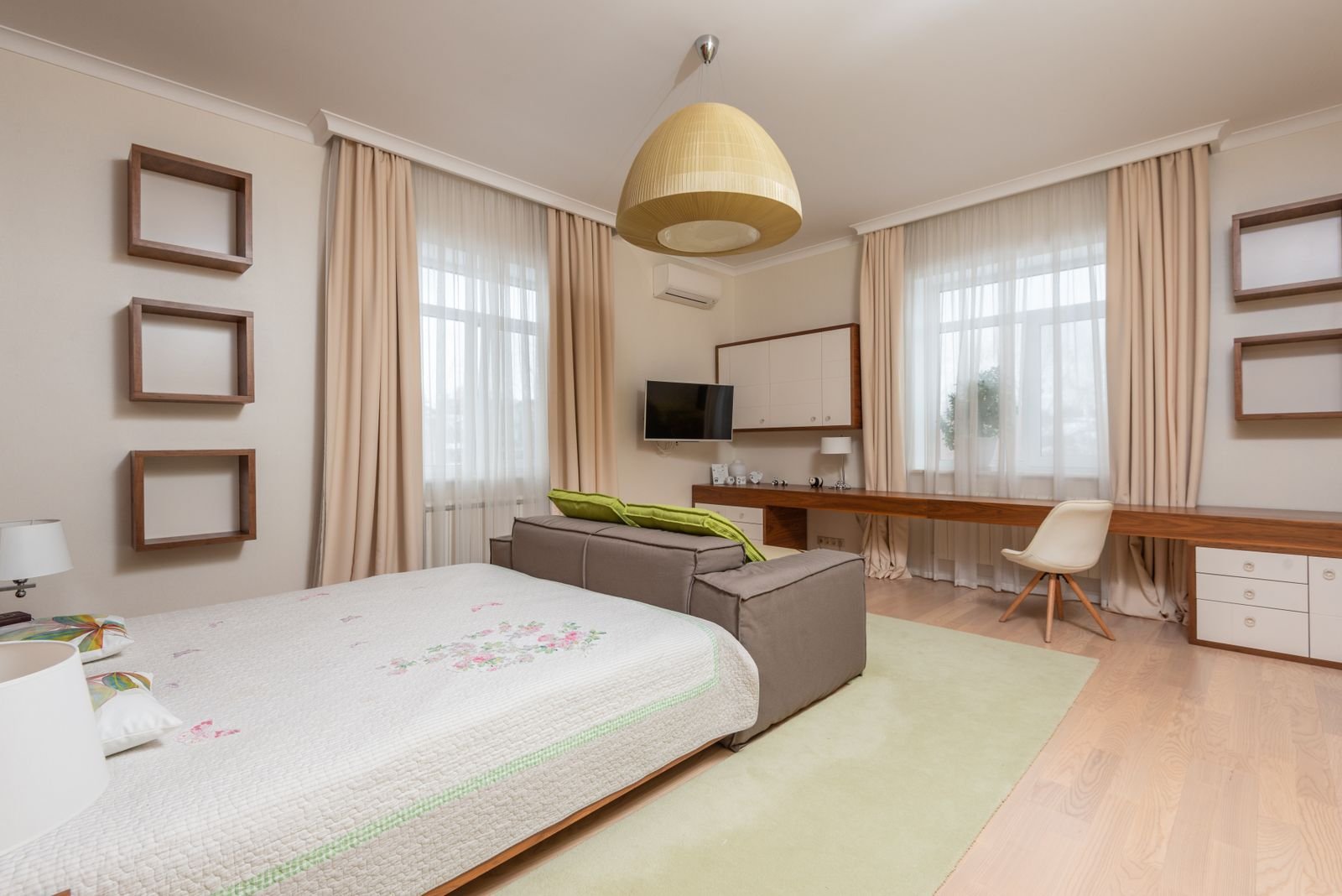 Modern apartment interior with beige curtains and a wooden table.