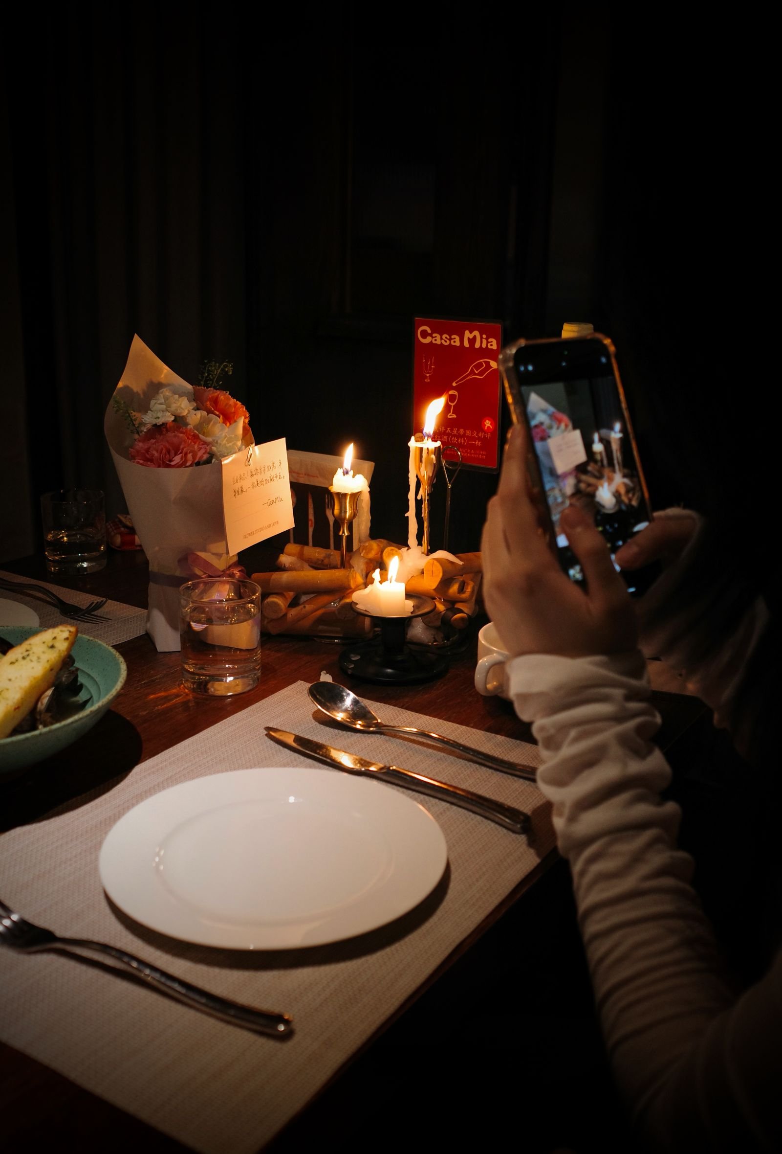 Cozy candlelit dinner setting with elegant tableware.