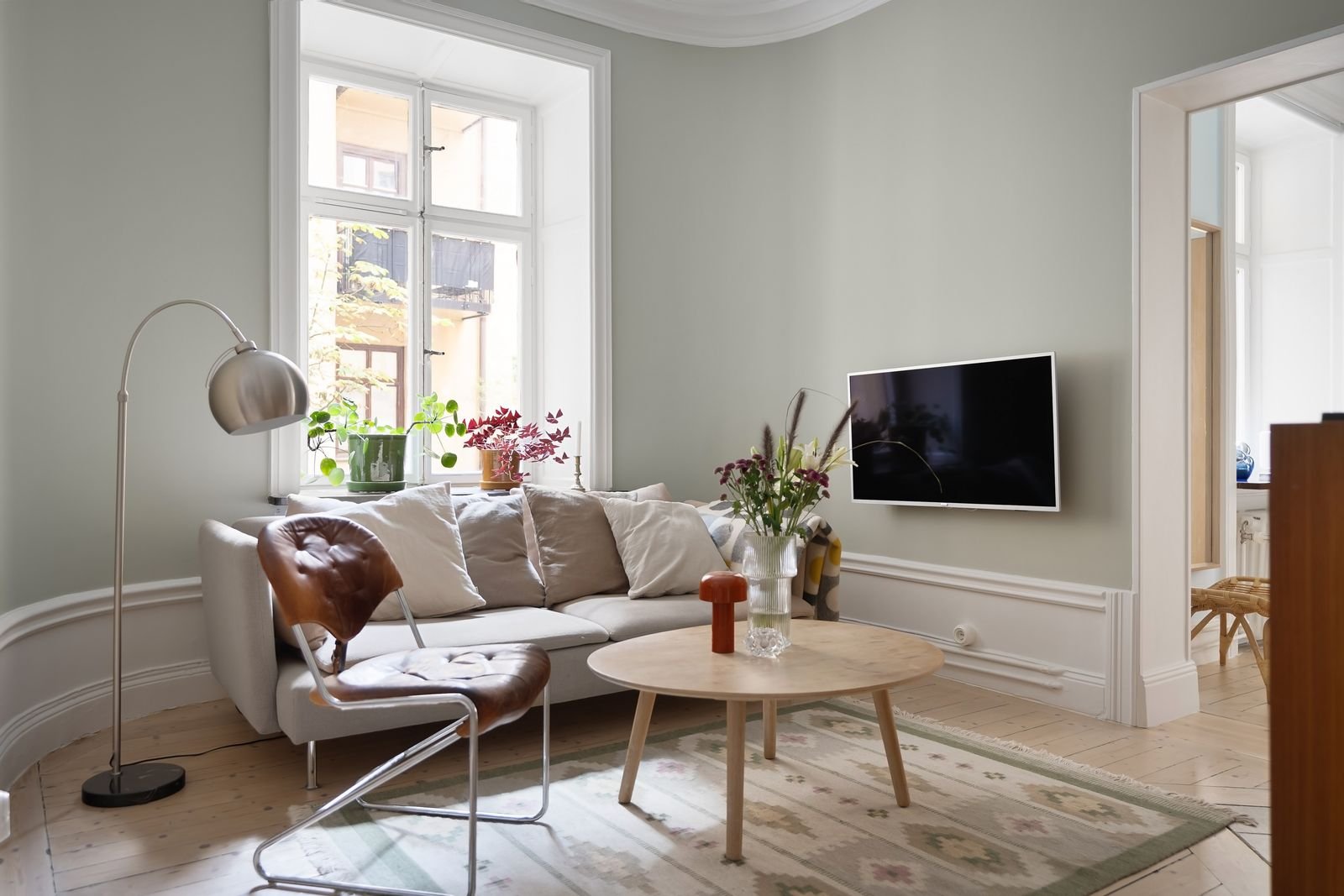 Minimalist living room with a sofa and bright natural light.