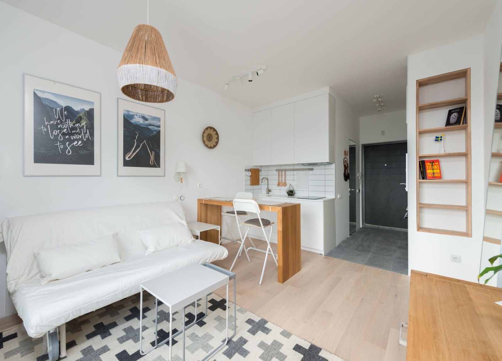 Light apartment living room with a couch, cushions and wooden furniture.