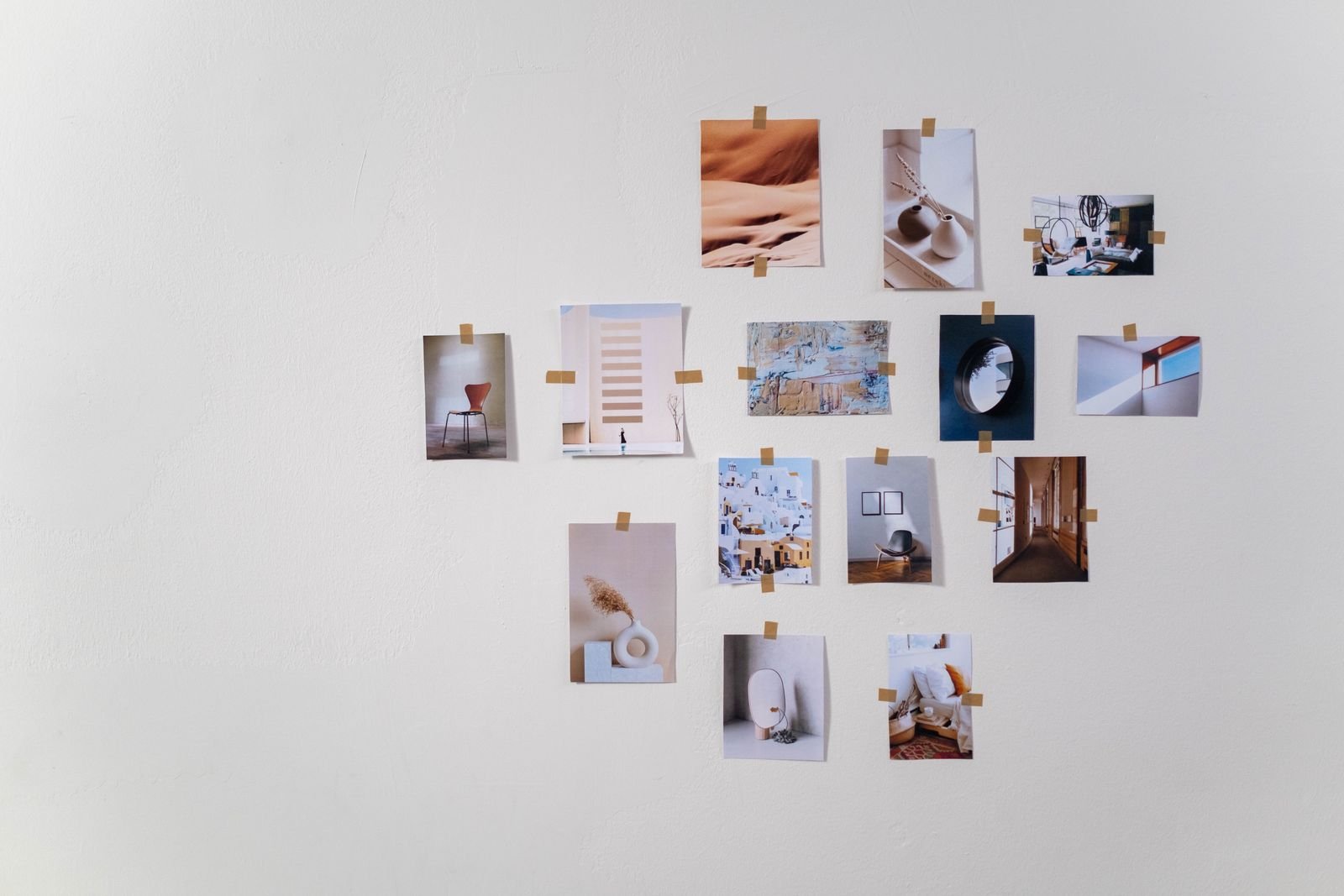 Minimalist collage of photographs arranged on a wall.