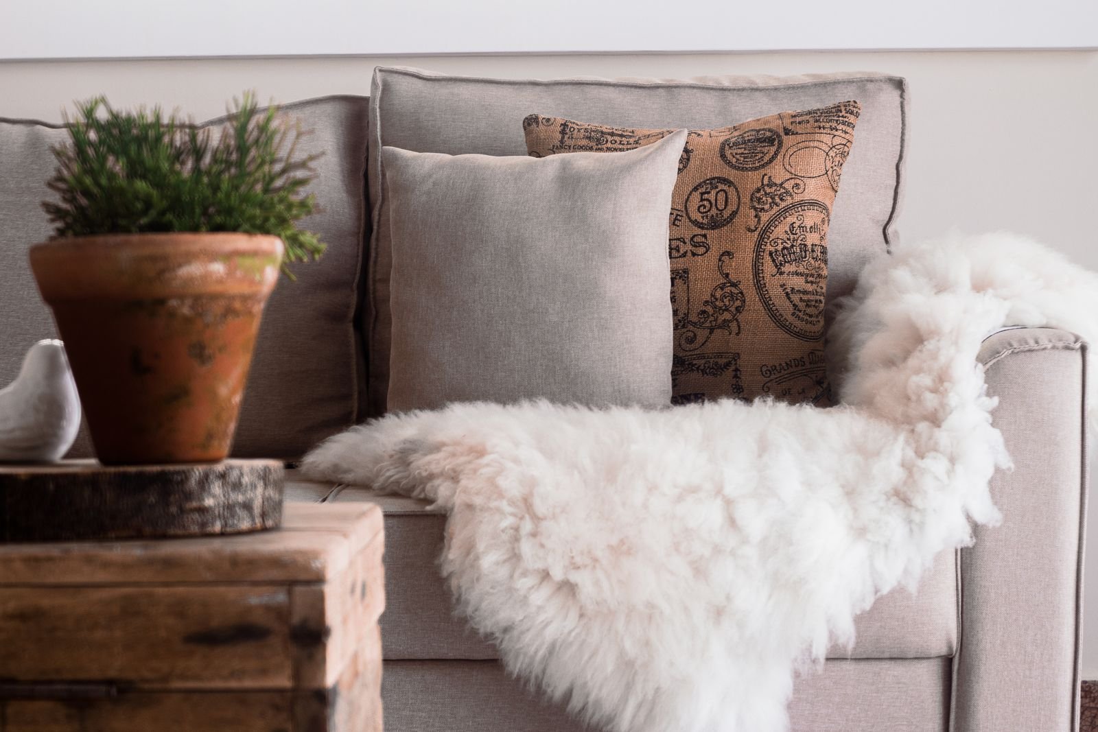 Sofa with fur throws and decorative pillows.